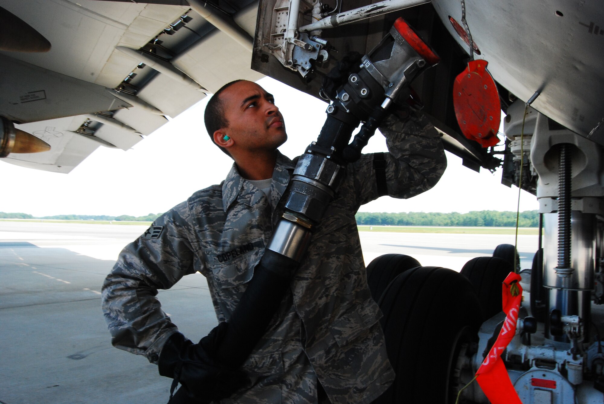 Senior Airman Isiah Copeland attaches a single-point nozzle to a C-5 receptacle in preparation for an aircraft refuel. SrA Copeland is the 22nd Air Force Air Reserve Component Fuels Airman of the Year. He, along with five co-workers, will now compete at the Air Force Reserve Command level. Twenty-second Air Force also named the 512th LRF as the recipient of the Daedalian Maj. Gen. Warren R. Carter Logistics Readiness Award. (U.S. Air Force photo) 