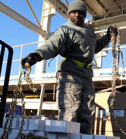 Staff Sgt. Curtis Priester prepares to move chains so a mine-resistant, ambush-protected all-terrain vehicle can be tied down and loaded onto a C-17 here Jan. 5. With each M-ATV weighing approximately 25,000 pounds, technicians exercise extreme care when handling the equipment. Sergeant Priester is an air transportation specialist with the 81st Aerial Port Squadron. (U.S. Air Force photo/Senior Airman Katie Gieratz)(RELEASED)