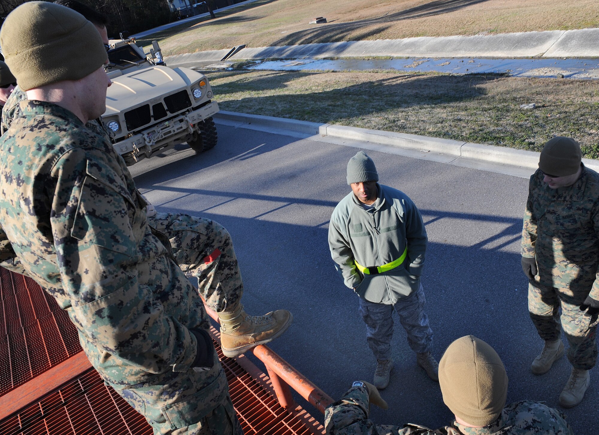 Tech. Sgt. Adrian Dailey, center, speaks to a group of Marines from the 4th Landing Support Battalion about new procedures being put into place for vehicle cargo loading here Jan. 5. The 437th Aerial Port Squadron cargo services center began shipping M-ATVs in September and will continue working with the Marines to prepare M-ATV shipments into the spring. Sergeant Dailey is the NCOIC of cargo services. (U.S. Air Force photo/Senior Airman Katie Gieratz)(RELEASED)