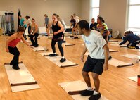 MINOT AIR FORCE BASE, N.D. -- Cheri Charboneau, 5th Force Support Squadron fitness instructor, motivates her sliders class during the Aerobathon at the McAdoo Sports and Fitness Center here Jan. 9. The 5th FSS created the Aerobathon to introduce a variety of aerobic classes offered to base personnel.. (U.S. Air Force photo by Senior Airman Michael J. Veloz)