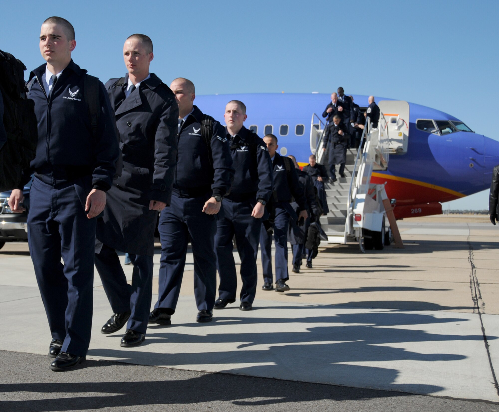 The first 82 technical training students disembark and head for inprocessing Monday.  (U.S. Air Force photo by Kemberly Groue)