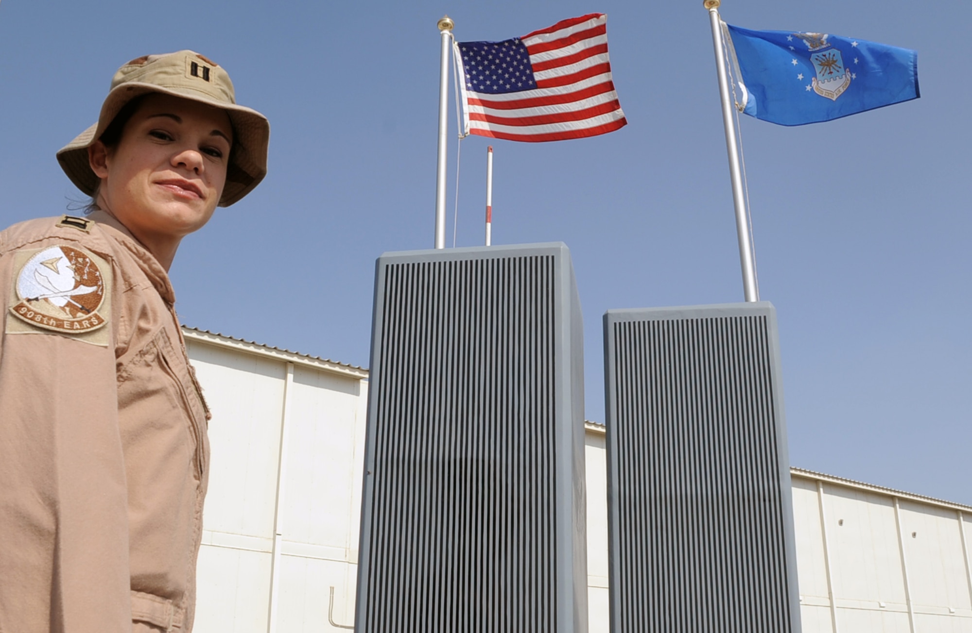 Capt. Hillary Wykes, a KC-10 Extender pilot with the 908th Expeditionary Air Refueling Squadron, stands by the 380th Air Expeditionary Wing's Sept. 11, 2001, memorial at a non-disclosed base in Southwest Asia on Jan. 13, 2010. Captain Wykes is a six-year Air Force veteran and recently completed her 100th combat sortie.  On Sept. 11, 2001, Captain Wykes was a flight attendant for United Airlines.  She said those events changed her life and led to her joining the military and becoming a pilot. Captain Wykes is deployed from the 9th Air Refueling Squadron at Travis Air Force Base, Calif., and her hometown is Plano, Ill. (U.S. Air Force Photo/Tech. Sgt. Scott T. Sturkol/Released)