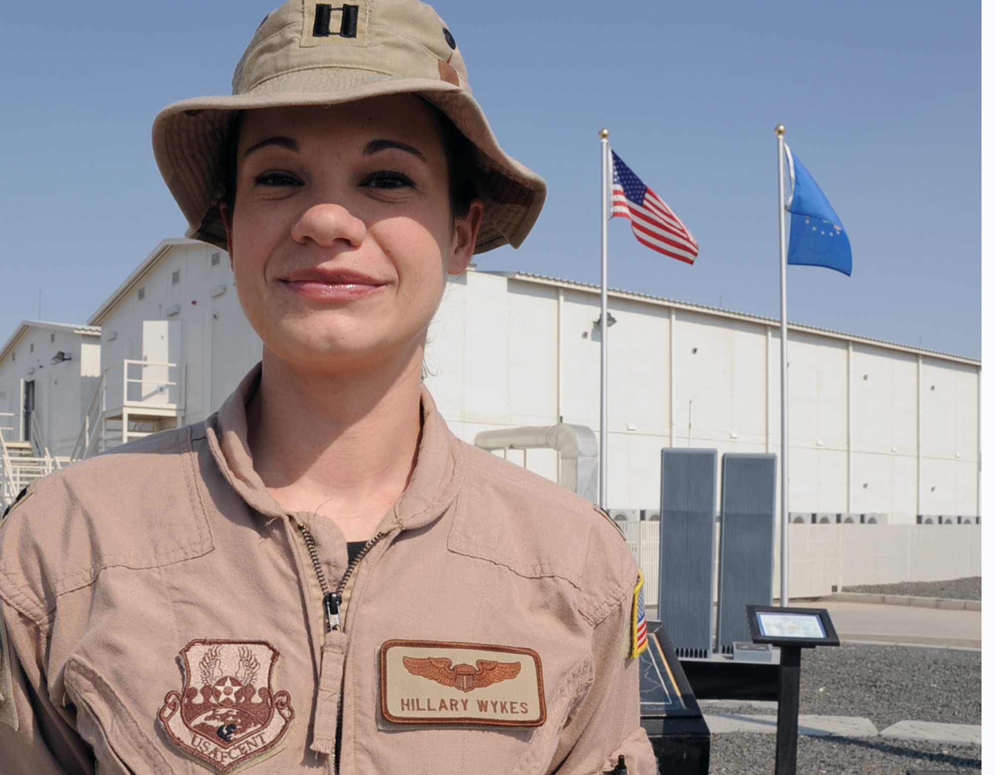Capt. Hillary Wykes, a KC-10 Extender pilot with the 908th Expeditionary Air Refueling Squadron, stands by the 380th Air Expeditionary Wing's Sept. 11, 2001, memorial at a non-disclosed base in Southwest Asia on Jan. 13, 2010. Captain Wykes is a six-year Air Force veteran and recently completed her 100th combat sortie.  On Sept. 11, 2001, Captain Wykes was a flight attendant for United Airlines.  She said those events changed her life and led to her joining the military and becoming a pilot. Captain Wykes is deployed from the 9th Air Refueling Squadron at Travis Air Force Base, Calif., and her hometown is Plano, Ill. (U.S. Air Force Photo/Tech. Sgt. Scott T. Sturkol/Released)