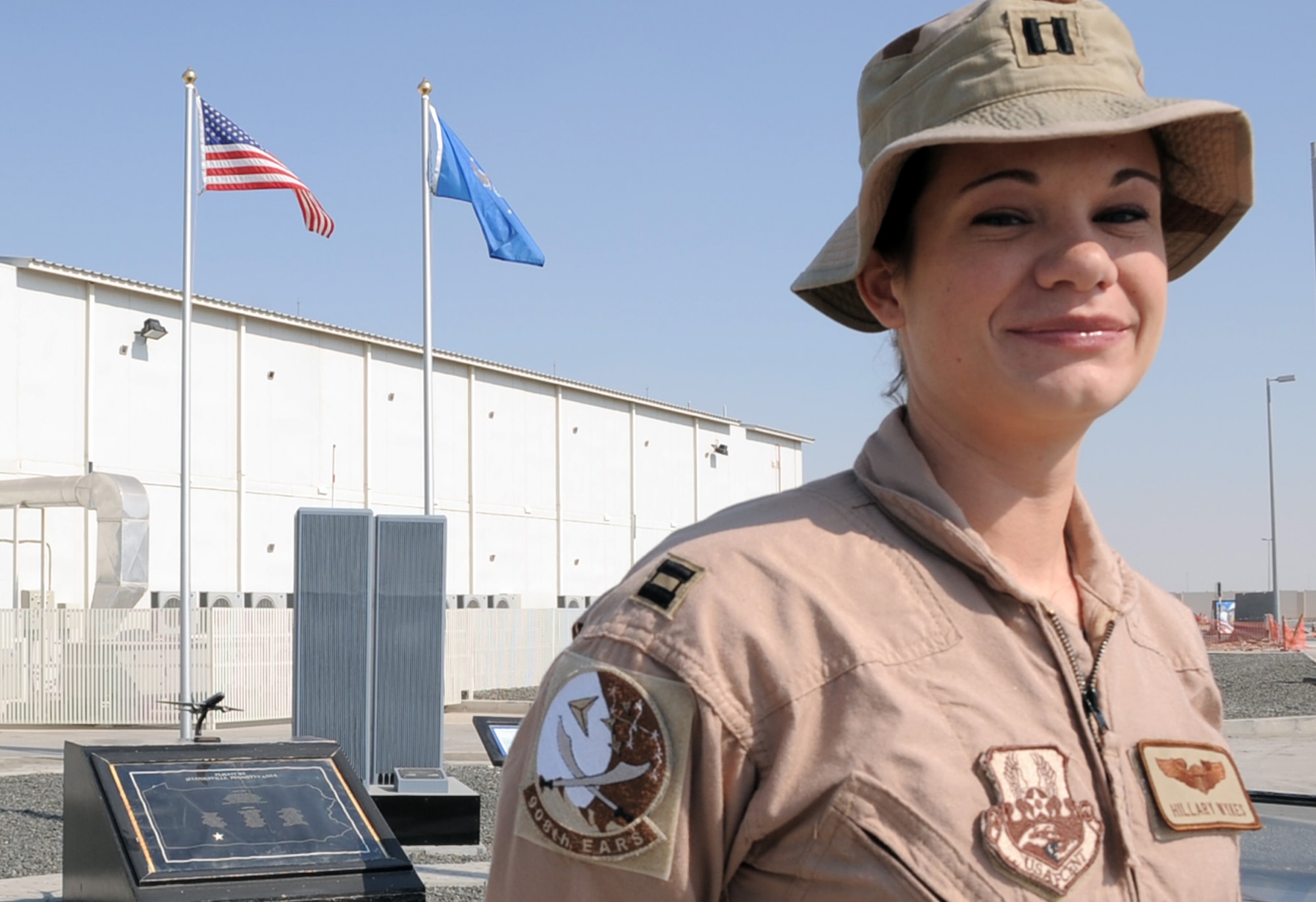 Capt. Hillary Wykes, a KC-10 Extender pilot with the 908th Expeditionary Air Refueling Squadron, stands by the 380th Air Expeditionary Wing's Sept. 11, 2001, memorial at a non-disclosed base in Southwest Asia on Jan. 13, 2010. Captain Wykes is a six-year Air Force veteran and recently completed her 100th combat sortie.  On Sept. 11, 2001, Captain Wykes was a flight attendant for United Airlines.  She said those events changed her life and led to her joining the military and becoming a pilot. Captain Wykes is deployed from the 9th Air Refueling Squadron at Travis Air Force Base, Calif., and her hometown is Plano, Ill. (U.S. Air Force Photo/Tech. Sgt. Scott T. Sturkol/Released)