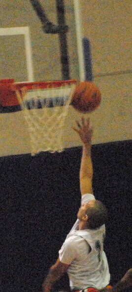 Jonathan Carrion, 436th Communications Squadron intramural basketball team guard, goes for a layup Jan. 6. The 436th CS defeated 436th Aircraft Maintenance Squadron with a score of 31-11. (U.S. Air Force photo/Airman 1st Class Matthew Hubby)