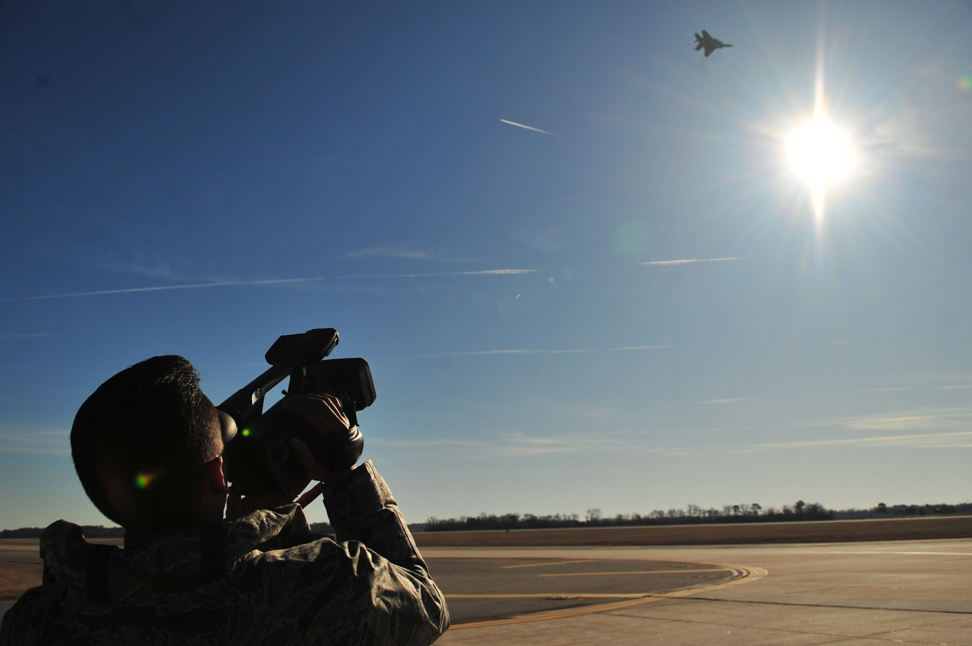 Tech. Sgt. Marc Rodriguez, 4th Fighter Wing Strike Eagle Demonstration Team assistant team leader, films a demonstration team's practice flight at Seymour Johnson Air Force Base, N.C., Jan. 10, 2010.  The team uses the film to critic the flight so the aircrew can see any improvements they need to make. The film is also sent to Air Combat Command, for review of how various demonstration teams are doing. Rodriguez hails from Dinuba, Calif. (U.S. Air Force photo/Airman 1st Class Rae Perry)