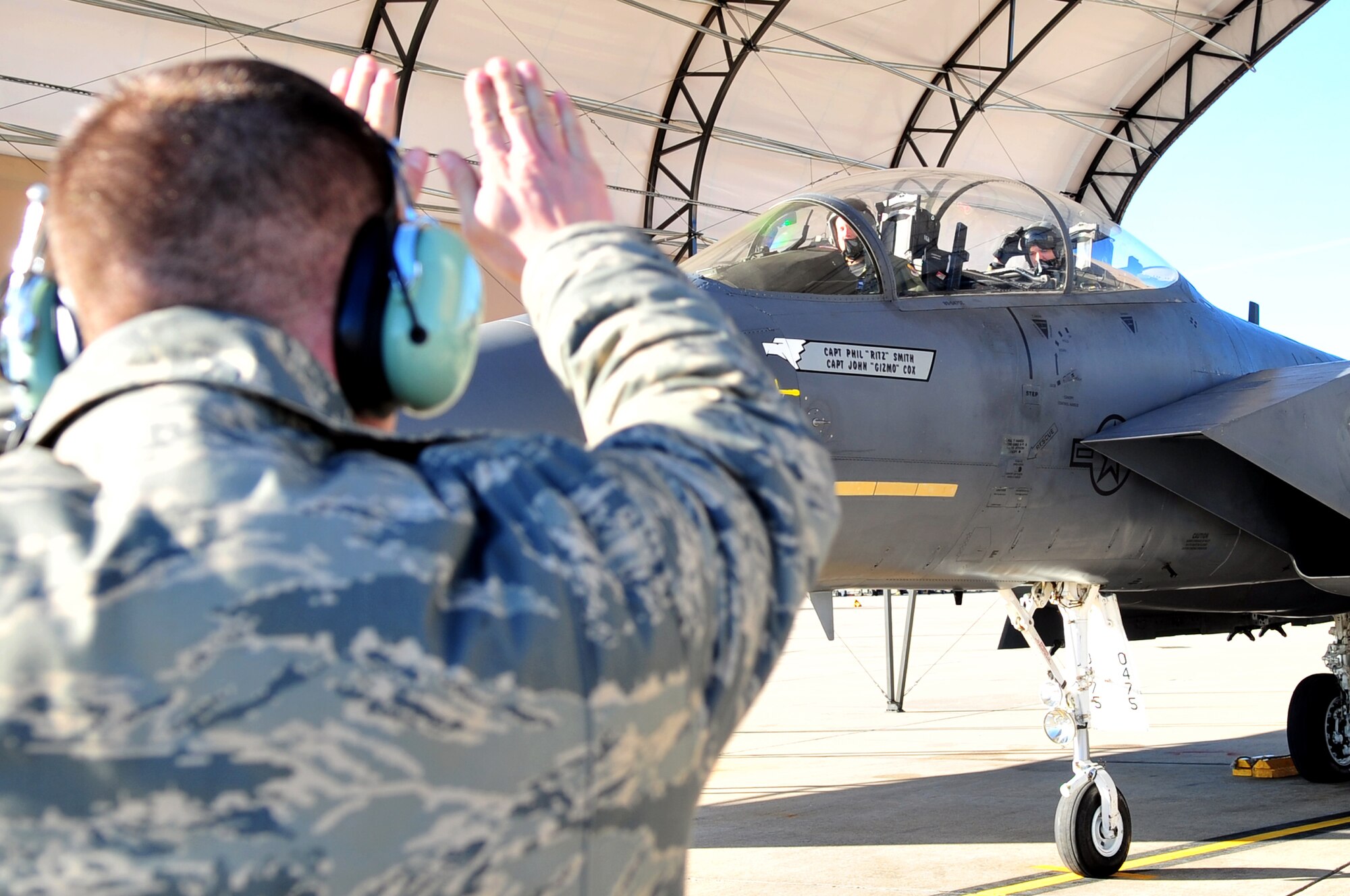 Senior Airman Brandon Rhodes, 4th Fighter Wing Strike Eagle Demonstration Team crew chief, directs the F-15E aircrew before giving the all clear for flight on Seymour Johnson Air Force Base, N.C., Jan. 11, 2010. The demonstration team performs their show without any verbal communication from the crew chiefs on the ground. Rhodes hails from Wichita Falls, Texas. (U.S. Air Force photo/Airman 1st Class Rae Perry)