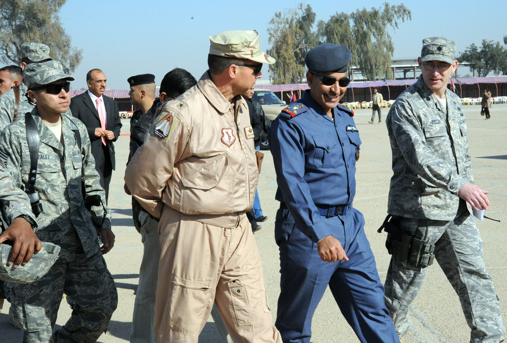 U.S. Air Force Chief Master Sgt. Ruben Gonzalez, 321st Air Expeditionary Wing Command Chief (left), Brig. Gen. Scott Hanson, Iraq Training and Advisory Mission - Air Force Director, Staff Brigadier General Pilot Ali, Dean of the Iraqi air force academy, and Lt.Col. David Keller, Chief Air Force Officers Program for the Iraq Training and Advisory Mission-Air Force, walk together after an Iraqi air force officer graduation ceremony on Iraqi Military Academy-Rustamiyah, Iraq, Jan 10, 2010.This graduating class is the last class that will graduate from this facility due to the mission moving to another location. (U.S. Air Force photo/Master Sgt. Trish Bunting/Released)