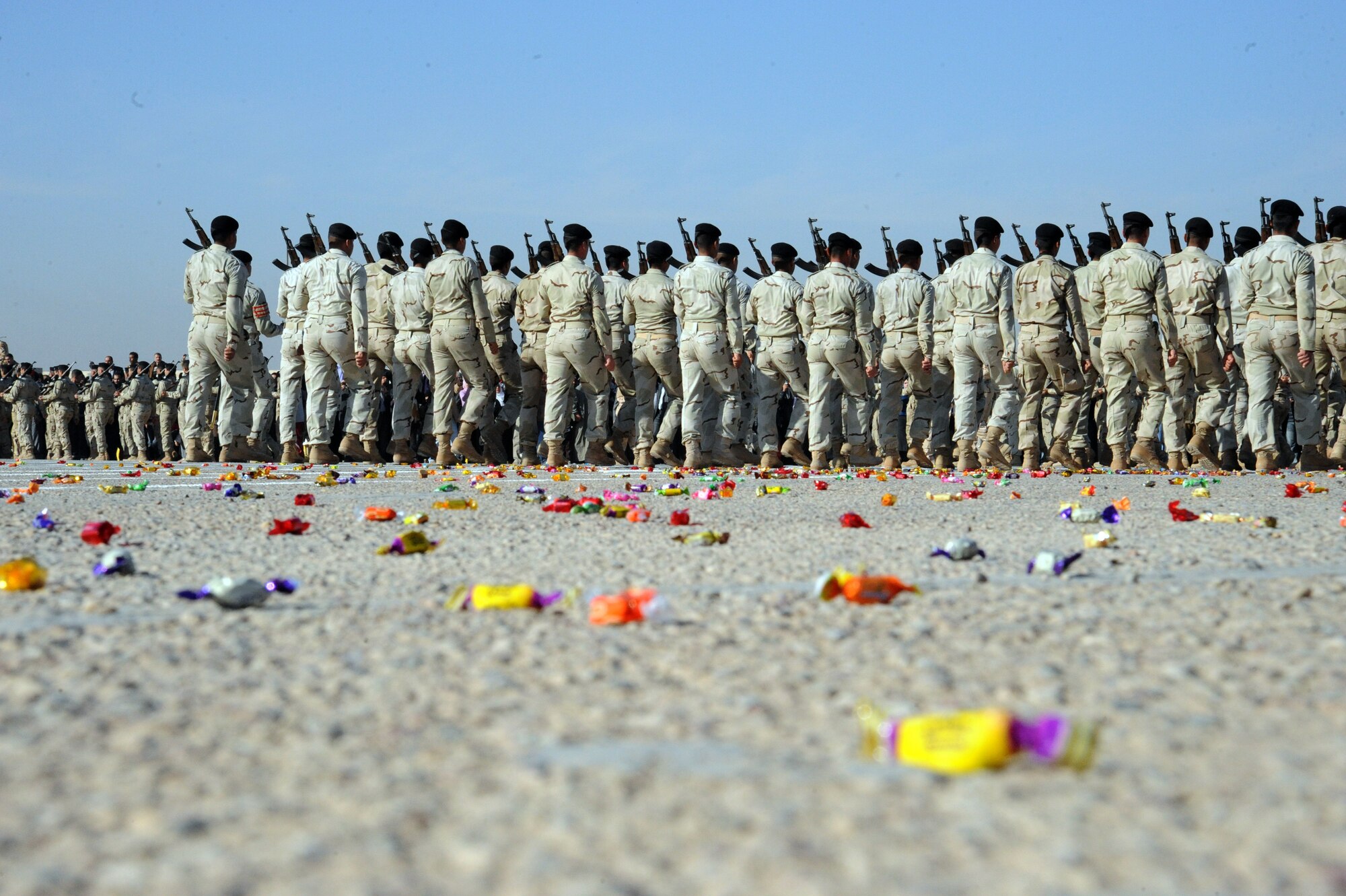 Candy covers the parade grounds during a pass in review at an Iraqi air force officer graduation ceremony on Iraqi Military Academy-Rustamiyah, Iraq, Jan. 10, 2010. As a friendly gesture, family and friends who attended the ceremony threw candy at the cadets as they marched by. (U.S. Air Force photo/Master Sgt. Trish Bunting/Released)