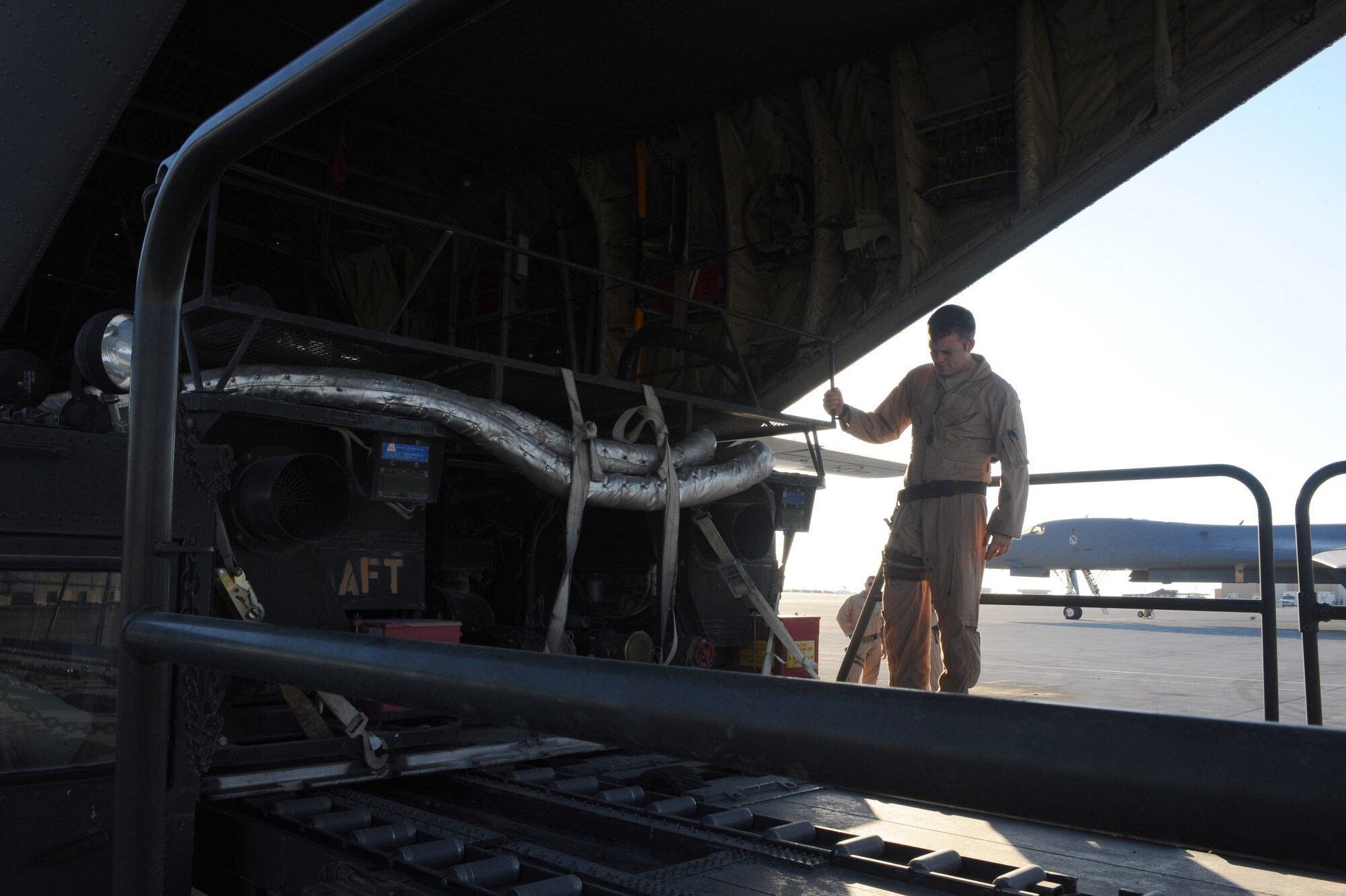 100109-F-3622Z-063
Staff Sgt. Garrett Hamilton, 746th Expeditionary Airlift Squadron loadmaster, unloads palletized equipment from a C-130 Hercules aircraft at a non-disclosed Southwest Asia location Jan. 9, 2010.  The C-130 can be rapidly reconfigured for the various types of cargo such as palletized equipment, floor-loaded material, airdrop platforms, container delivery system bundles, vehicles and personnel or aeromedical evacuation. (U.S. Air Force photo by Senior Airman Kasey Zickmund)[RELEASED]
