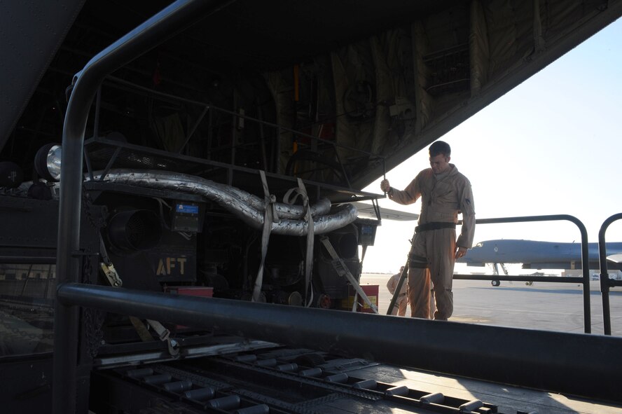 100109-F-3622Z-063Staff Sgt. Garrett Hamilton, 746th Expeditionary Airlift Squadron loadmaster, unloads palletized equipment from a C-130 Hercules aircraft at a non-disclosed Southwest Asia location Jan. 9, 2010.  The C-130 can be rapidly reconfigured for the various types of cargo such as palletized equipment, floor-loaded material, airdrop platforms, container delivery system bundles, vehicles and personnel or aeromedical evacuation. (U.S. Air Force photo by Senior Airman Kasey Zickmund)[RELEASED]