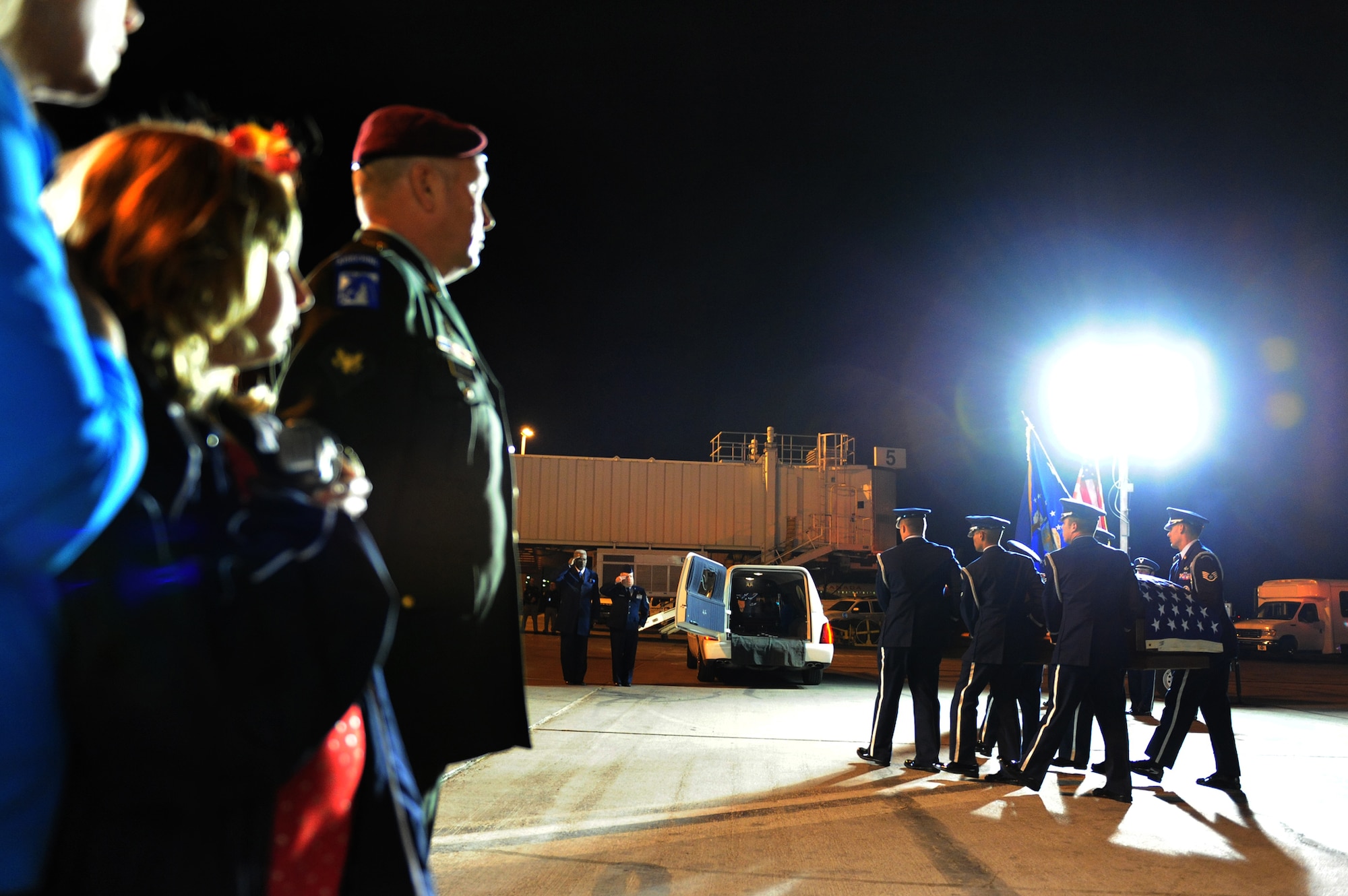 LAS VEGAS-- Russell Goodman (in uniform), along with his sisters, Christine and Deborah, look on as members of the Nellis Air Force Base Honor Guard provide a dignified transfer for the remains of their father, Maj. Russell C. Goodman, a U.S. Air Force pilot that was killed in action during the Vietnam War, from a Hawaiian Airlines flight at McCarran International Airport Jan. 12. Major Goodman served as the narrator for the U.S. Air Force Air Demonstration Squadon "Thunderbirds" from 1964-65 and was declared missing in action after his aircraft was hit by a surface-to-air missile Feb. 20, 1967, while on a combat mission over North Vietnam. At the time of his loss, Major Goodman was still assigned to the Thunderbirds and was flying with the U.S. Navy on an exchange program. Funeral services for Major Goodman will take place at the Thunderbirds Hangar on Nellis AFB at Jan. 14. He is to be buried in Alaska at a date determined by his family. (U.S. Air Force Photo by Staff Sgt. William P. Coleman/RELEASED)
