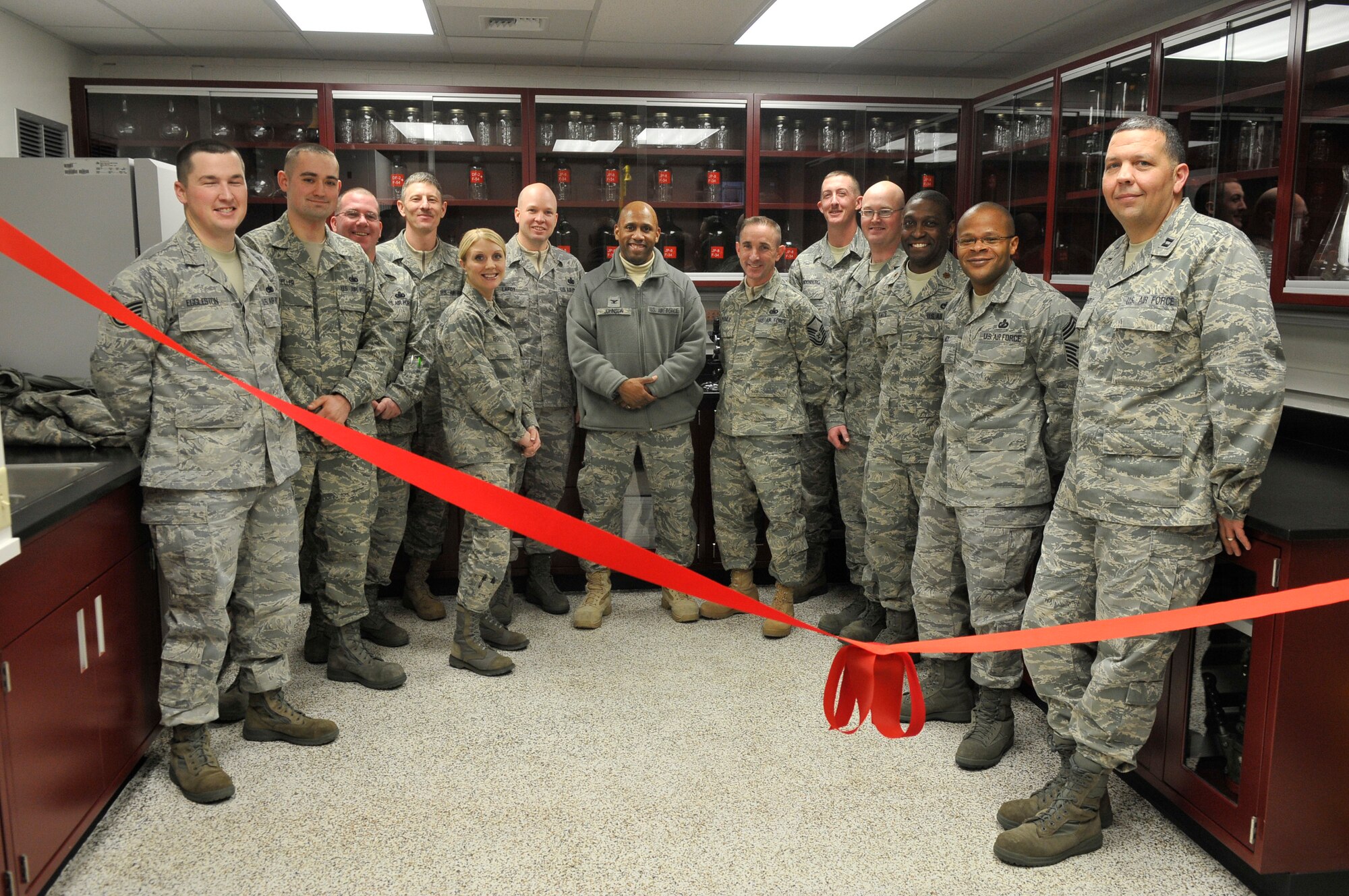The 354th Logistics Readiness Squadron Petroleum, Oils and Lubricants Flight pose  during the ribbon cutting ceremony Dec. 15, 2009, at Eielson Air Force Base. The flight gathered to celebrate the completion and opening of the renovated laboratory. (U.S. Air Force photo/Airman 1st Class Janine Thibault)