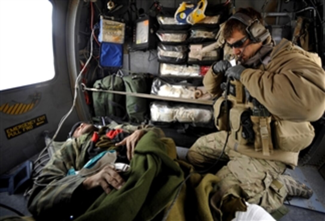 U.S. Air Force pararescuemen from the 66th Expeditionary Rescue Squadron deployed to Camp Bastion, Afghanistan, provide medical attention to an Afghan who has suffered gunshot injuries on Dec. 8, 2009.  The pararescuemen will administer medical care while in transit to a medical facility.  
