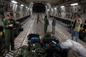 Team Charleston members wait to depart for McGuire Air Force Base, N.J., Jan. 14 to pick up humanitarian supplies to deliver to Haiti following the devastating 7.0 –magnitude earthquake that hit Tuesday morning. The Air Force's airlift capability enables the U.S. to respond immediately to any disaster domestically or worldwide. The U.S. is the only country with an aircraft fleet capable of providing this type of response. (U.S. Ai r Force photo/ Airman 1st Class Lauren Main)