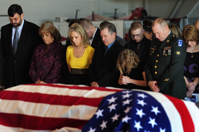 NELLIS AIR FORCE BASE, Nev.-- Friends and family of Major Russell Goodman pray during the funeral service held inside the Thunderbird hanger, Jan. 14, 2010.  Maj. Goodman served as the narrator for the U.S. Air Force Thunderbirds from 1964-65 and was declared Missing-In-Action after his aircraft was hit by a surface-to-air missile in Feb. 1967, while on a combat mission over North Vietnam.
(U.S. Air Force Photo by Staff Sgt. William P. Coleman)
