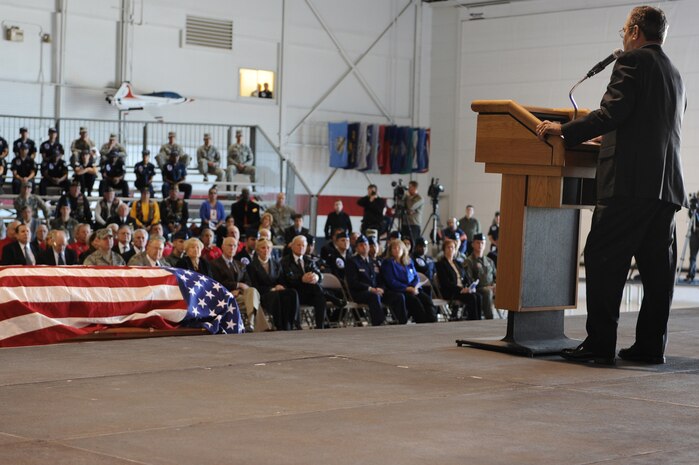 NELLIS AIR FORCE BASE, Nev.-- Navy Cmdr. (ret) Gary Thornton speaks during the repatriation and funeral ceremony for Maj. Russel C. Goodman at the Thunderbird hanger on Nellis AFB, Jan. 14. Maj. Goodman served as the narrator for the U.S. Air Force "Thunderbirds" from 1964-65 and was declared Missing-In-Action after his aircraft was hit by a surface-to-air missile in Feb. 1967, while on a combat mission over North Vietnam. (U.S. Air Force photo by Tech. Sgt. Michael R. Holzworth)