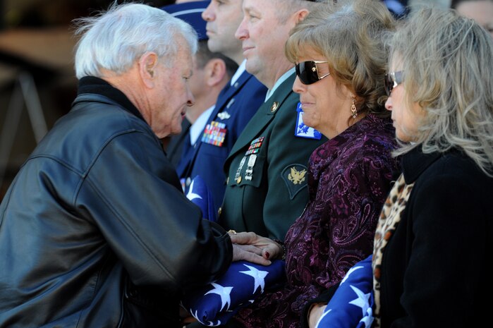 NELLIS AIR FORCE BASE, Nev.-- Former Thunderbird commander Brig. Gen. (ret) Paul Kauttu presents a folded American flag to Mrs. Christine Stonebraker during the repatriation and funeral ceremony for Maj. Russel C. Goodman at the Thunderbird hanger on Nellis AFB, Jan. 14, 2010. Mrs Stonebraker is the daughter of Maj. Goodman who served as the narrator for the U.S. Air Force Thunderbirds from 1964-65 and was declared Missing-In-Action after his aircraft was hit by a surface-to-air missile in Feb. 1967, while on a combat mission over North Vietnam.
(U.S. Air Force photo by Tech. Sgt. Michael R. Holzworth)
