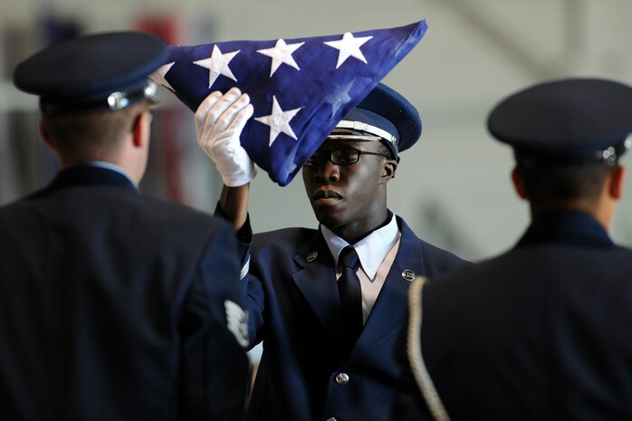 NELLIS AIR FORCE BASE, Nev.-- Airman 1st Class Erastus Odongo of the Nellis Honor Guard dresses the flag during the repatriation and funeral ceremony in honor of Maj. Russel C. Goodman at the Thunderbird hanger on Nellis AFB, Jan. 14, 2010. Maj. Goodman served as the narrator for the U.S. Air Force Thunderbirds from 1964-65 and was declared Missing-In-Action after his aircraft was hit by a surface-to-air missile in Feb. 1967, while on a combat mission over North Vietnam.
(U.S. Air Force photo by Tech. Sgt. Michael R. Holzworth)