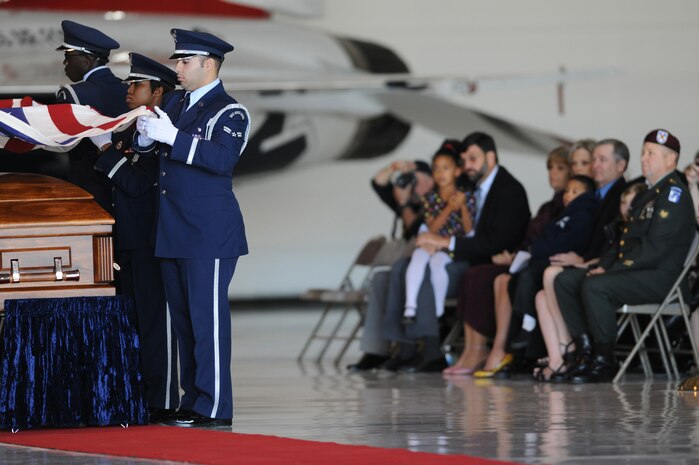 NELLIS AIR FORCE BASE, Nev.--  Nellis Honor Guard perform a the flag folding ceremony for the Goodman family during the repatriation and funeral ceremony in honor of Maj. Russel C. Goodman at the Thunderbird hanger on Nellis AFB, Jan. 14. Maj. Goodman served as the narrator for the U.S. Air Force "Thunderbirds" from 1964-65 and was declared Missing-In-Action after his aircraft was hit by a surface-to-air missile in Feb. 1967, while on a combat mission over North Vietnam.
(U.S. Air Force photo by Tech. Sgt. Michael R. Holzworth/RELEASED)