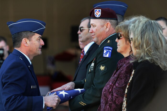 NELLIS AIR FORCE BASE, Nev.-- Brig. Gen. Russell Handy, 57th Wing commander presents former Army Spc. Russell Goodman, son of Maj. Russell C. Goodman an American flag during the repatriation and funeral service for Maj. Goodman Jan. 14.  Maj. Goodman served as the narrator for the U.S. Air Force Thunderbirds from 1964-65 and was declared Missing-In-Action after his aircraft was hit by a surface-to-air missile in Feb. 1967, while on a combat mission over North Vietnam.
(U.S. Air Force photo by Lawrence Crespo)