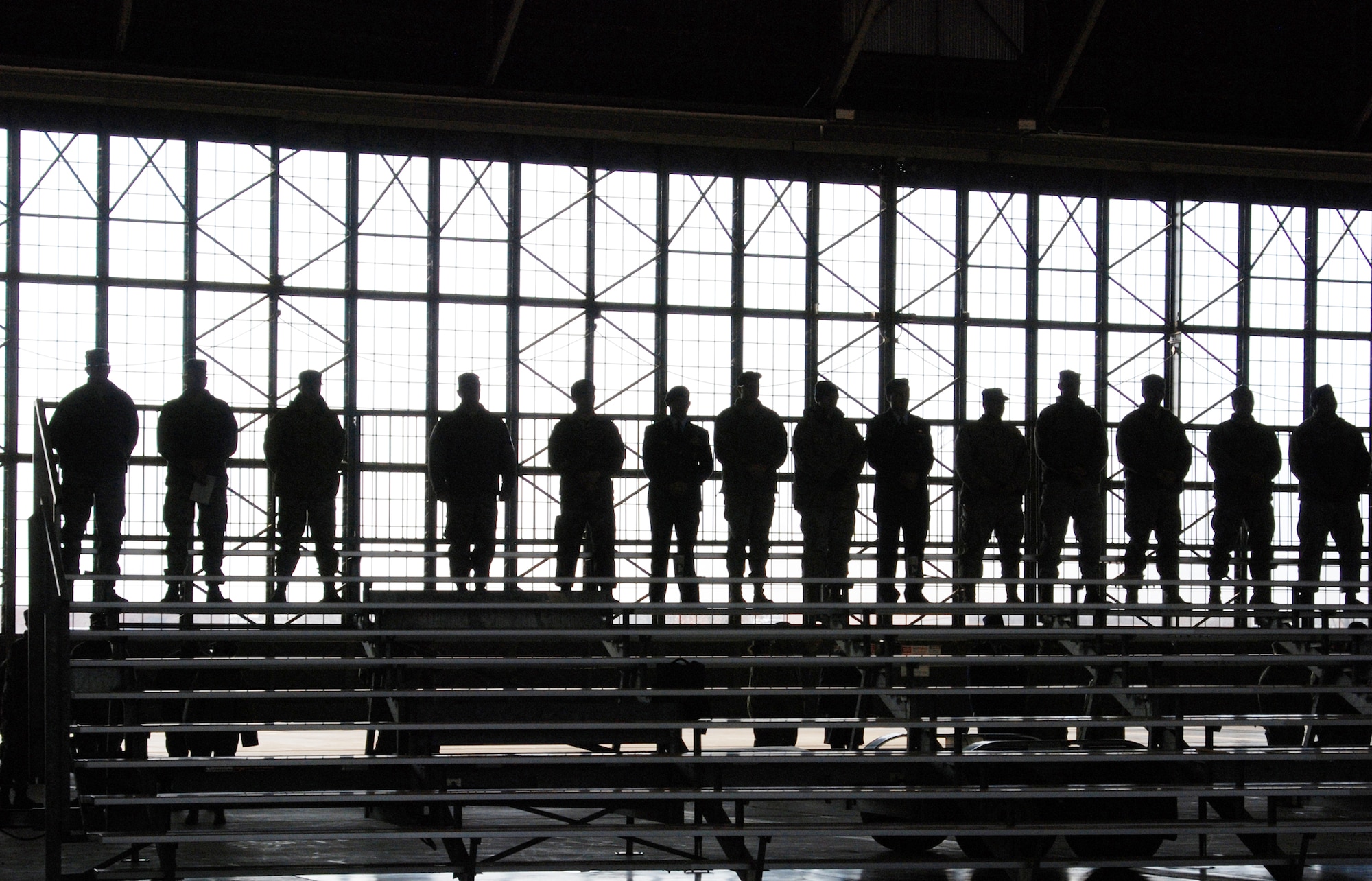 Air Force Reserve Command members are silhouetted by the doors of a hangar at Scott Air Force Base, Ill., Jan. 9, 2010. They were at a memorial service for Tech. Sgt. Anthony C. Campbell Jr. , a member of the 932nd Airlift Wing who was killed in action in Afghanistan Dec. 15, 2009. (U.S. Air Force photo/Tech. Sgt. Gerald Sonnenberg)