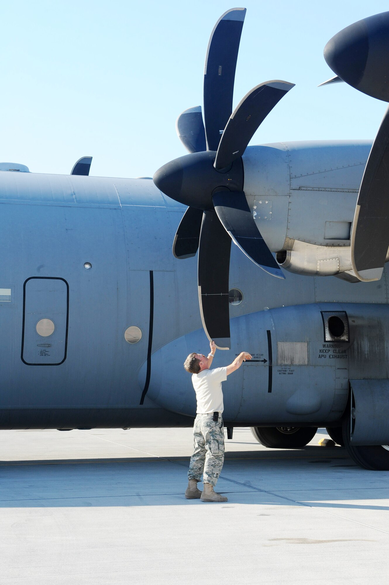 Chief Master Sgt. Michael Watson, the 746th Expeditionary Airlift Squadron operations superintendant, inspects the propellers of a C-130J Super Hercules as part of the pre-flight checklist at an air base in Southwest Asia Jan. 9, 2010. (U.S. Air Force photo/Senior Airman Kasey Zickmund)
