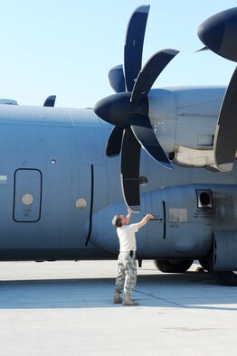 Chief Master Sgt. Michael Watson, the 746th Expeditionary Airlift Squadron operations superintendant, inspects the propellers of a C-130J Super Hercules as part of the pre-flight checklist at an air base in Southwest Asia Jan. 9, 2010. (U.S. Air Force photo/Senior Airman Kasey Zickmund)