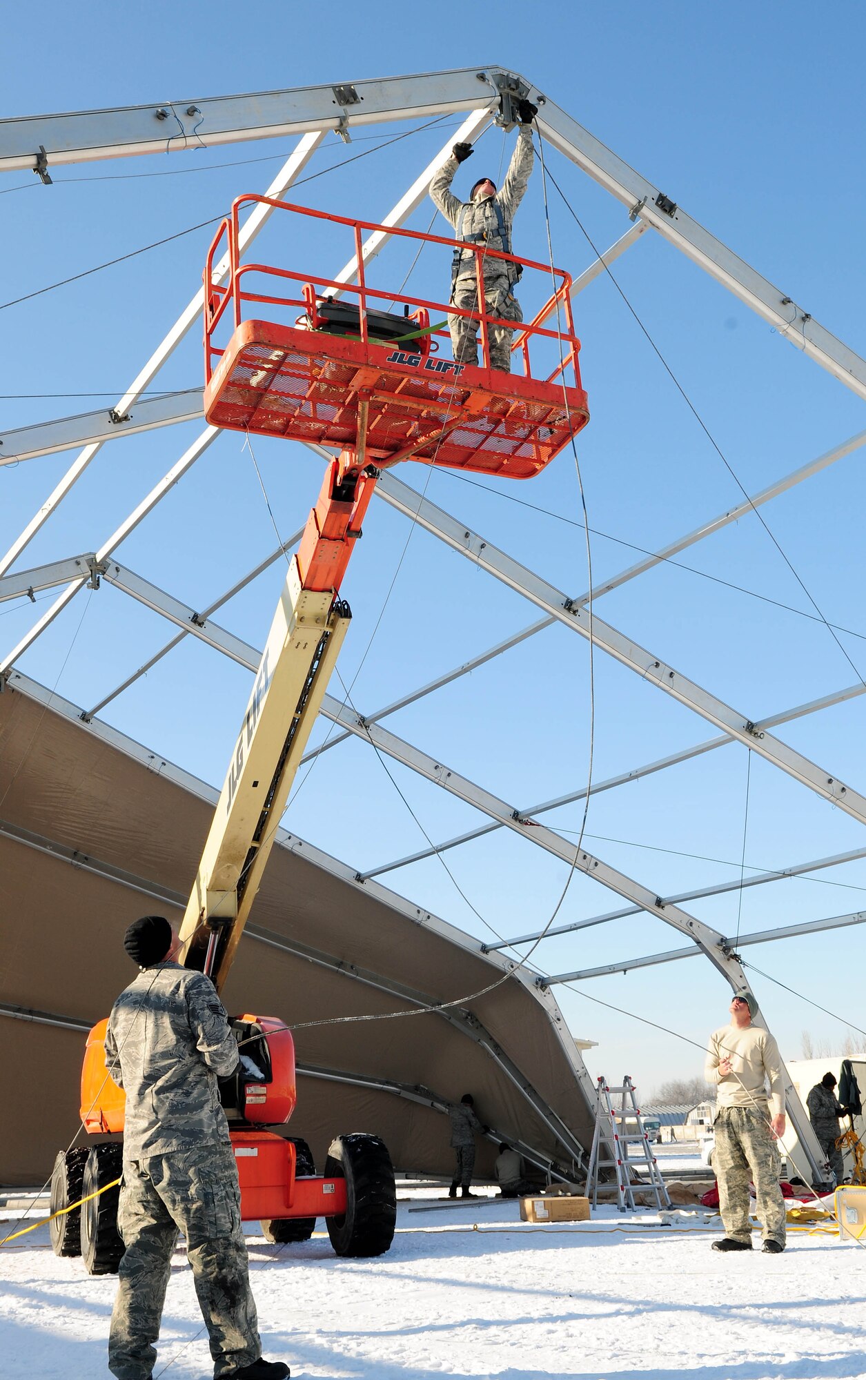 Airmen construct a new dome tent at the Transit Center at Manas, Kyrgyzstan, Jan. 11, 2010. The tents are being built to support the influx of Airmen, Soldiers, Sailors and Marines who pass through here. The Airmen are deployed from the 49th Material Maintenance Squadron at Holloman Air Force Base, N.M. (U.S. Air Force photo/Senior Airman Nichelle Anderson)