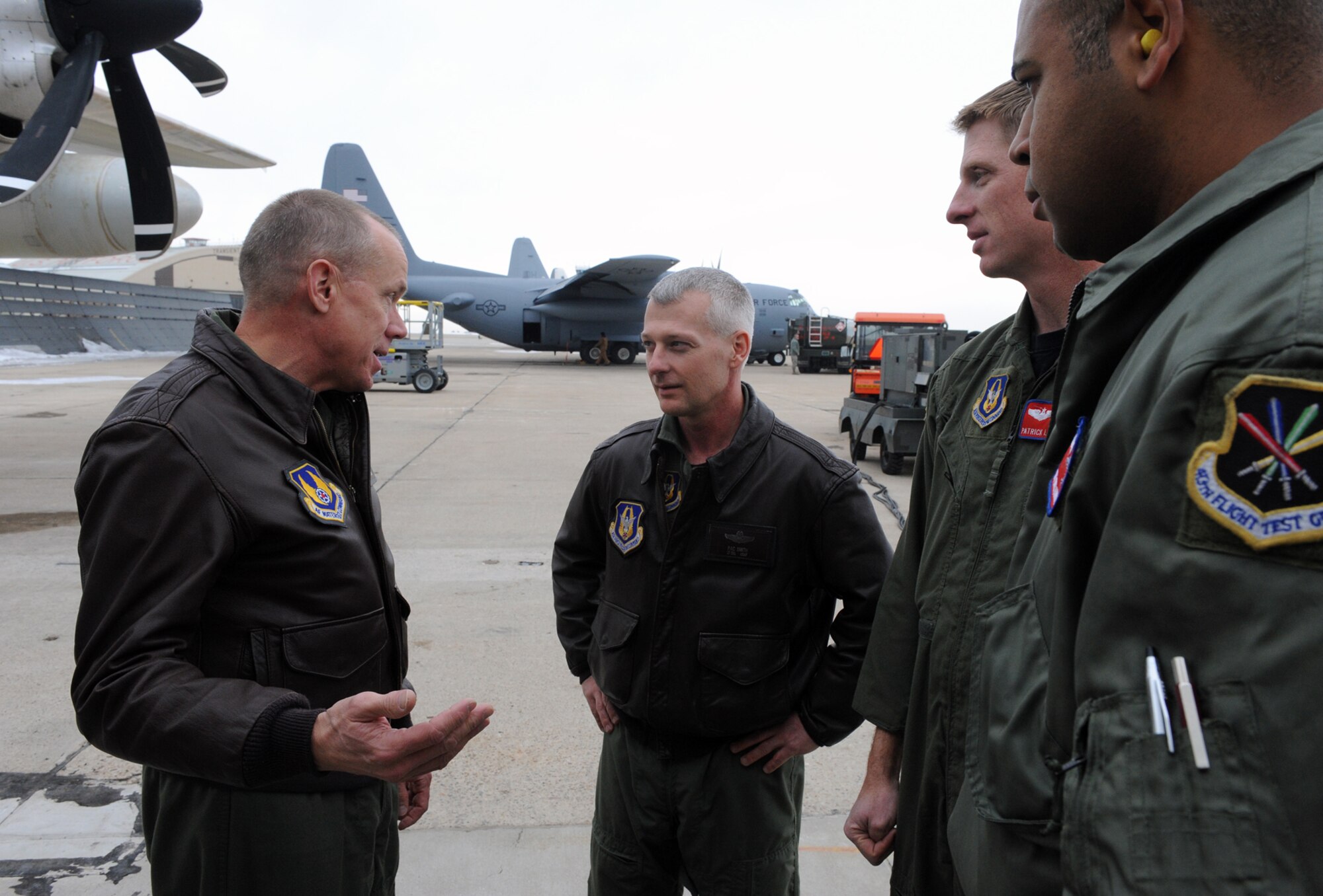 Gen Donald Hoffman (left to right), AFMC commander; Lt Col Pac Smith and Maj Patrick Leonard, 514  FLTS pilots; and MSgt Drew Harris, 514 FLTS loadmaster, talk on the tarmac before a flight in a Marine Corps C-130J Hercules at Hill Air Force Base on Jan. 12. General Hoffman visited Hill AFB Jan. 11-12. (USAF photos by ALEX LLOYD)
