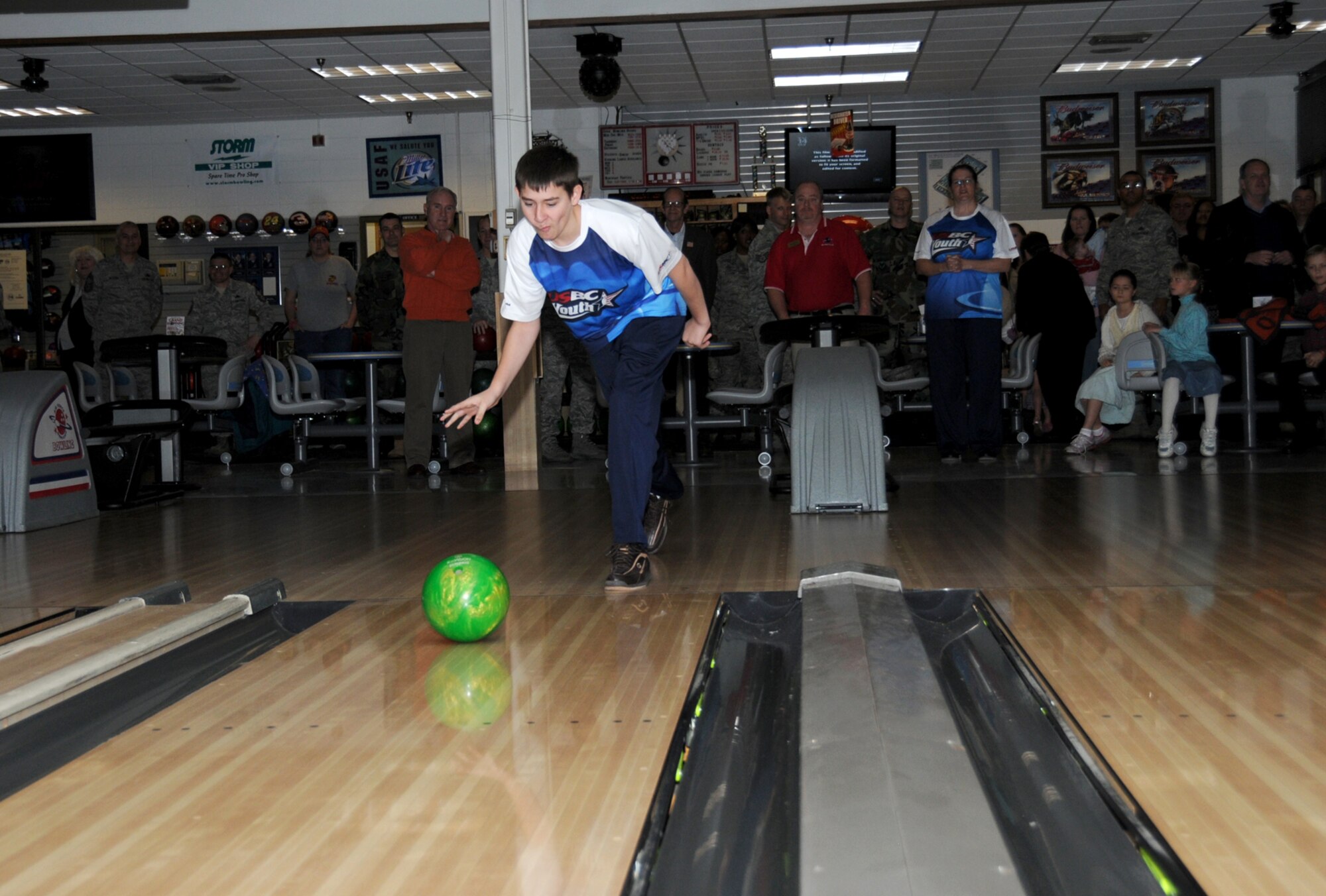 Samuel Bertrand, 14-year-old son of Staff Sgt. Mark and Florence Bertrand, 403rd Wing, rolls the first ball after the ribbon-cutting ceremony for the reopening of Gaudé Lanes Bowling Center Jan. 12.  He's a member of Keesler's youth bowling league.  (U.S. Air Force photo by Kemberly Groue)