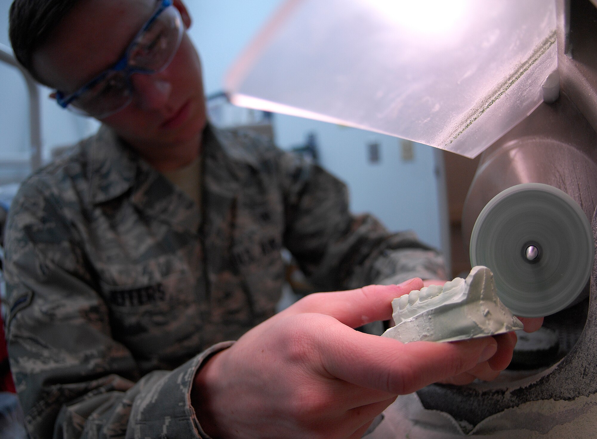 VANDENBERG AIR FORCE BASE, Calif. -- Working with precision, Airman Aaron Jeffers, a dental lab apprentice from the 30th Medical Operations Squadron here, grinds the cast of a bottom row of teeth to prepare it for a hard night guard here Tuesday, Jan. 12, 2010. (U.S. Air Force photo/Airman 1st Class Andrew Lee)