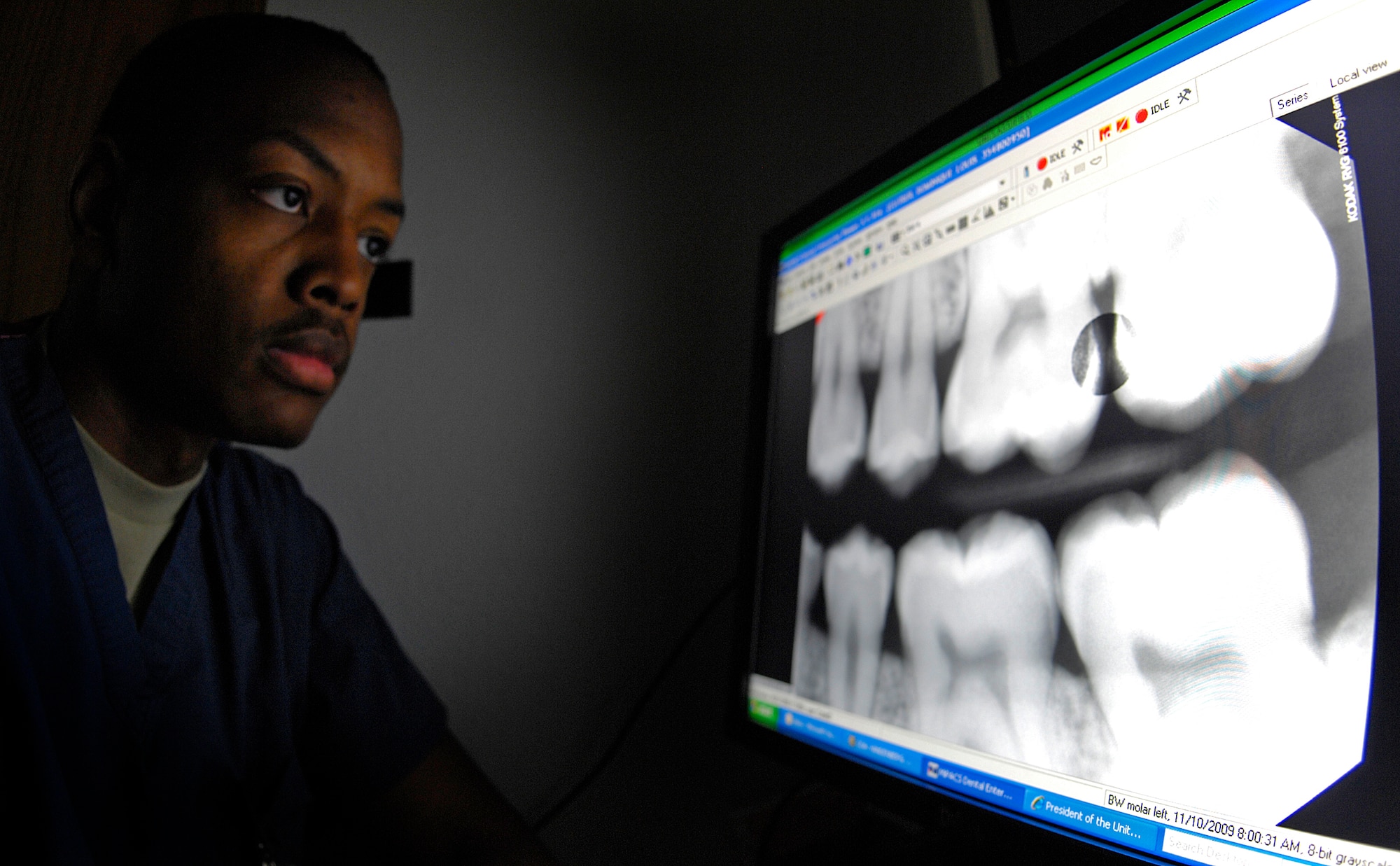 VANDENBERG AIR FORCE BASE, Calif. -- Looking for abnormalities, Senior Airman Dominique Cutrer, a dental technician from the 30th Medical Operations Squadron here, checks digital X-ray images of teeth here Jan. 12, 2010. The recent renovation to the dental clinic allows it to have an X-ray machine available in each room. (U.S. Air Force photo/Airman 1st Class Andrew Lee)

