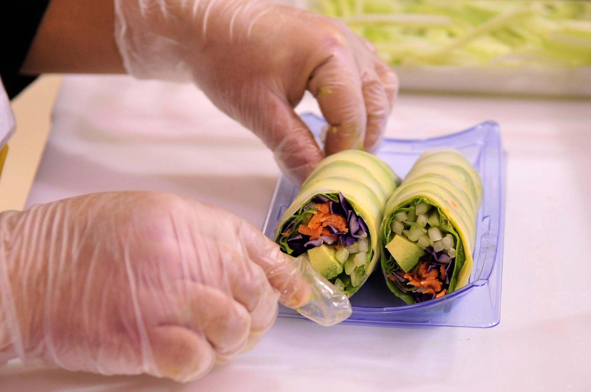 BUCKLEY AIR FORCE BASE, Colo. -- Commissary sushi stand co-owner Naum Dim arranges sushi rolls on trays to set out for sale Jan. 13. Ms. Dim has been in the sushi business since 2001. (U.S. Air Force photo by Airman 1st Class Manisha Vasquez)