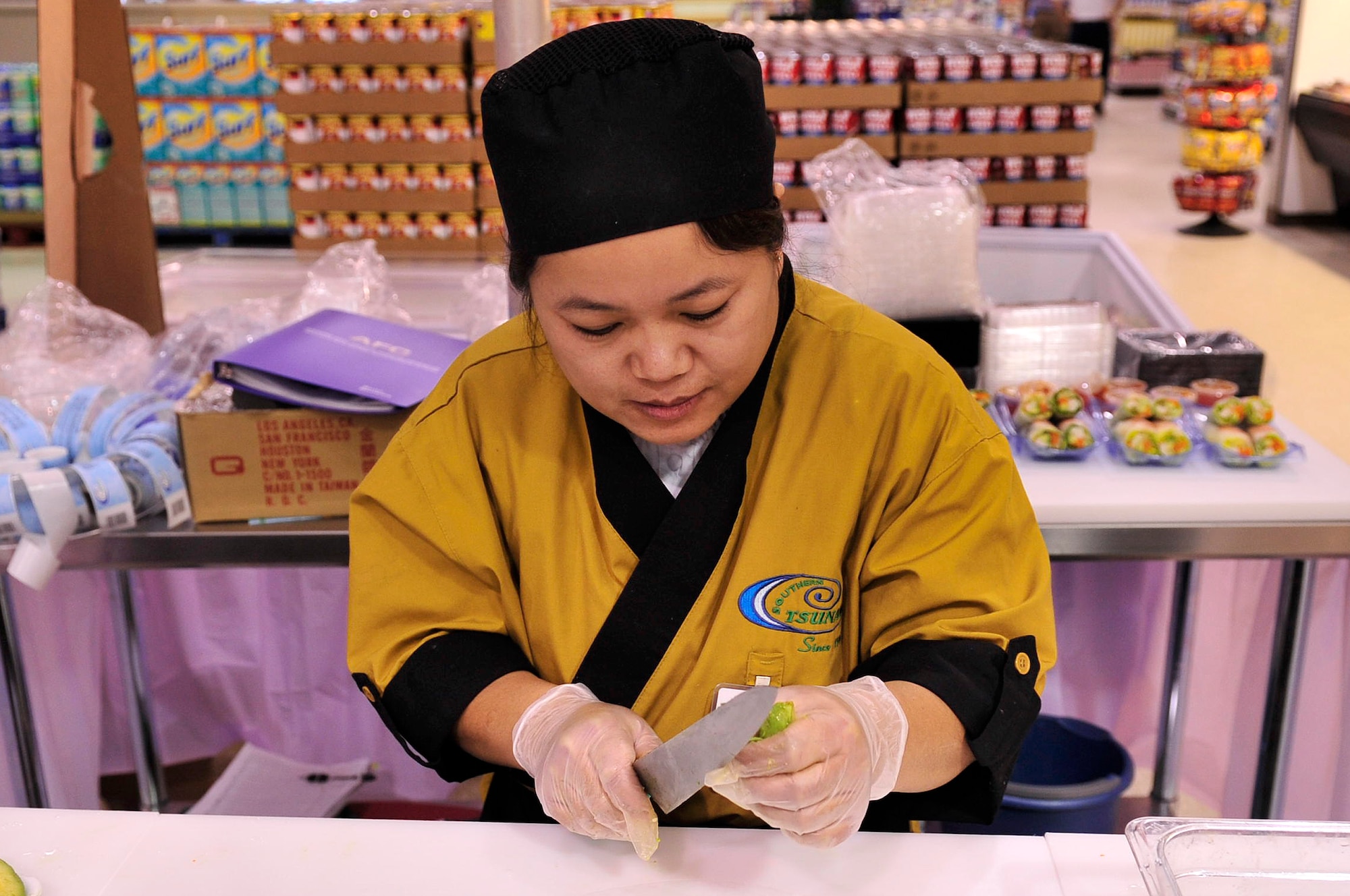 BUCKLEY AIR FORCE BASE, Colo.-- Naum Dim slices avocado to put in her freshly-made sushi Jan. 13. Naum and her husband have been in the sushi business since 2001. (U.S. Air Force photo by Airman 1st Class Manisha Vasquez)