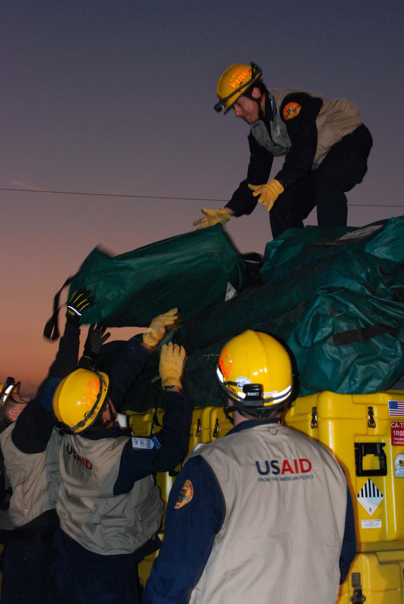Members of a USAID search and rescue team build a pallett for transport on a C-17. The USAID personnel, who are members of the Los Angeles County Fire Department, deployed to Haiti from March Air Reserve Base, Calif., Jan. 13.  The C-17 Globemaster III that transported the 72-person team and rescue equipment was from Travis Air Force Base, Calif.  (U.S. Air Force Photo/Staff Sgt. Megan Crusher, released)
