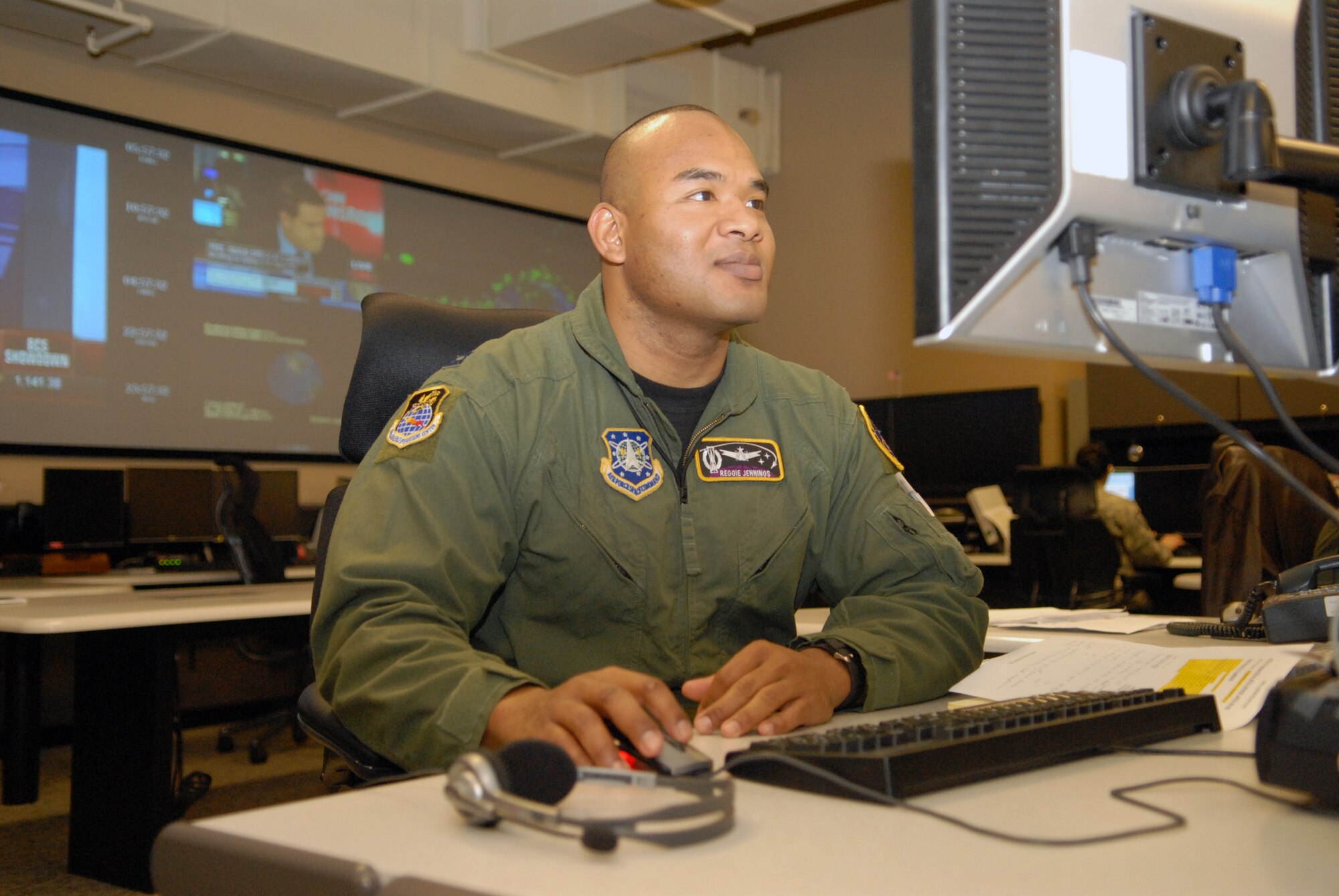 VANDENBERG AIR FORCE BASE, Calif. -- Utilizing his skills as a force enhancement duty officer, Capt. Reggie Jennings, of the Joint Space Operations Center here, works on the requests he received from the Joint Functional Component Command for Space here Thursday, Jan. 7, 2010. The Joint Space Operations Center here recently reached a milestone Dec. 18, increasing the number of active satellites tracked from 120 to approximately 1,150. (U.S. Air Force photo/Airman 1st Class Angelina Drake)