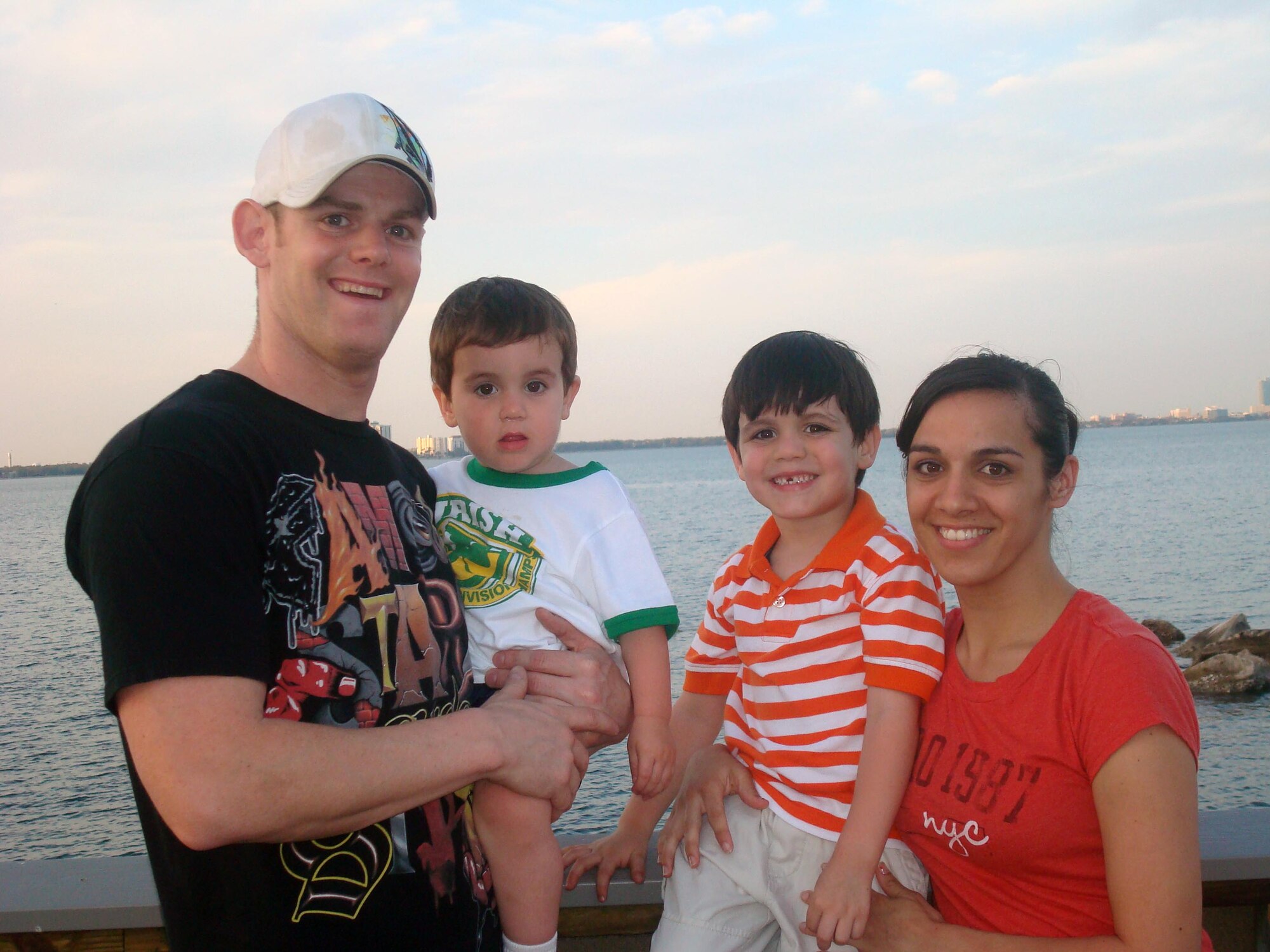 Tech Sgt. Elmer Smith, 4th Security Forces Squadron self inspection monitor, Senior Airman Sara Smith, 4th Aeromedical Dental Squadron occupational health technician, and their children Elijah, 3, and Ethan, 6, vacation at Disney World in Orlando, Fla., Oct. 13, 2009. In November, Sara earned a below-the- zone promotion to senior airman for her work as an occupational health technician. A month later, Elmer received a promotion to technical sergeant through the Stripes for Exceptional Performers Program. (Courtesy photo)              