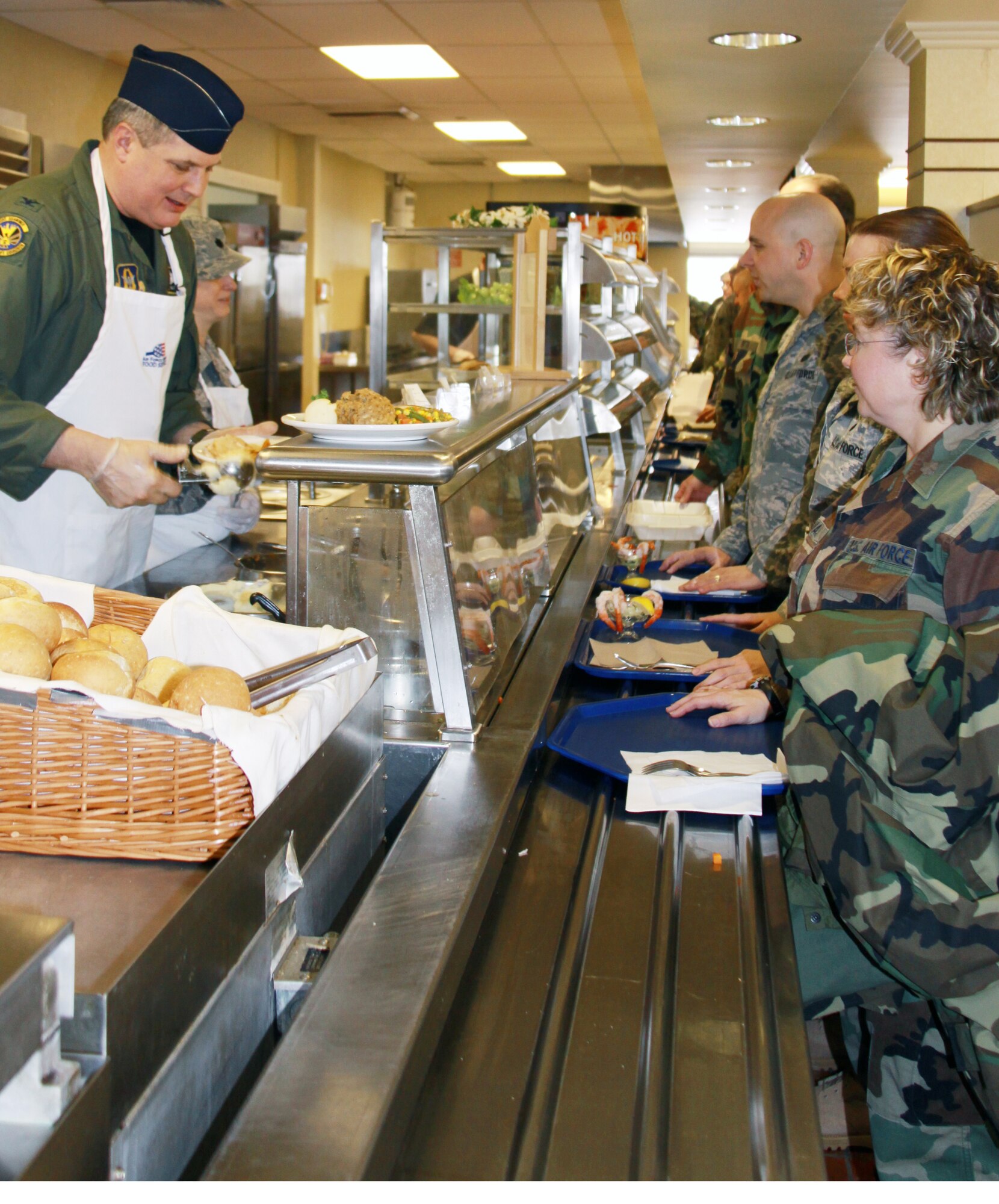 Col. Daryl Hartman, 911th Operations Group commander, serves lunch for the holiday meal, Jan. 9, 2010.  The group and squadron commander's each took their turn in serving the meal as part of the 911th Airlift Wing tradition.