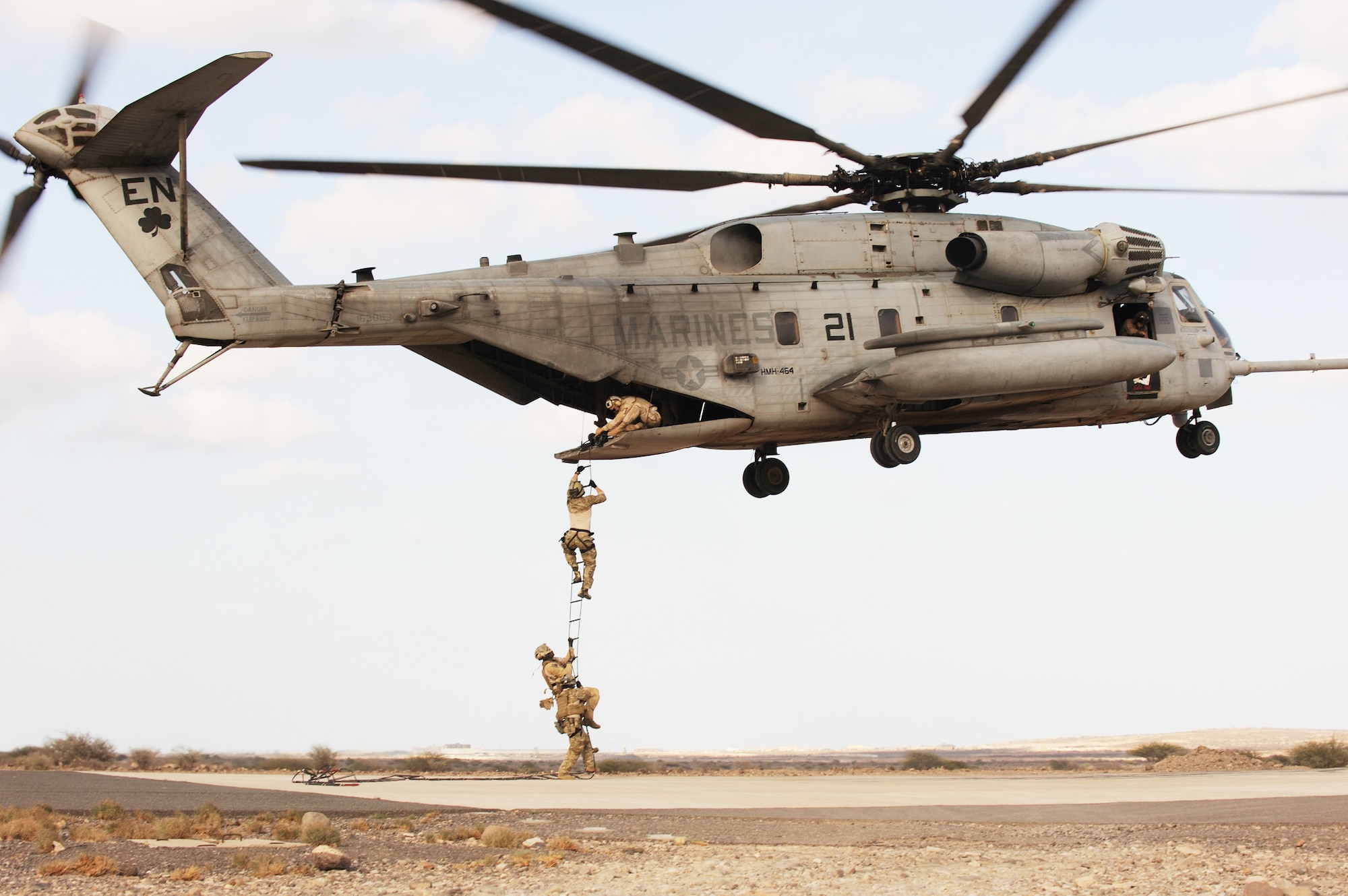 Air Force pararescuemen conduct a combat insertion and extraction exercise from a Marine CH-53 Sea Stallion helicopter in Djibouti, Africa, Jan. 5, 2010. The helicopter is attached to Heavy Marine Helicopter Squadron 464, and the two units are deployed to Combined Joint Task Force-Horn of Africa.  (U.S. Air Force photo/Master Sgt. Jeremiah Erickson)