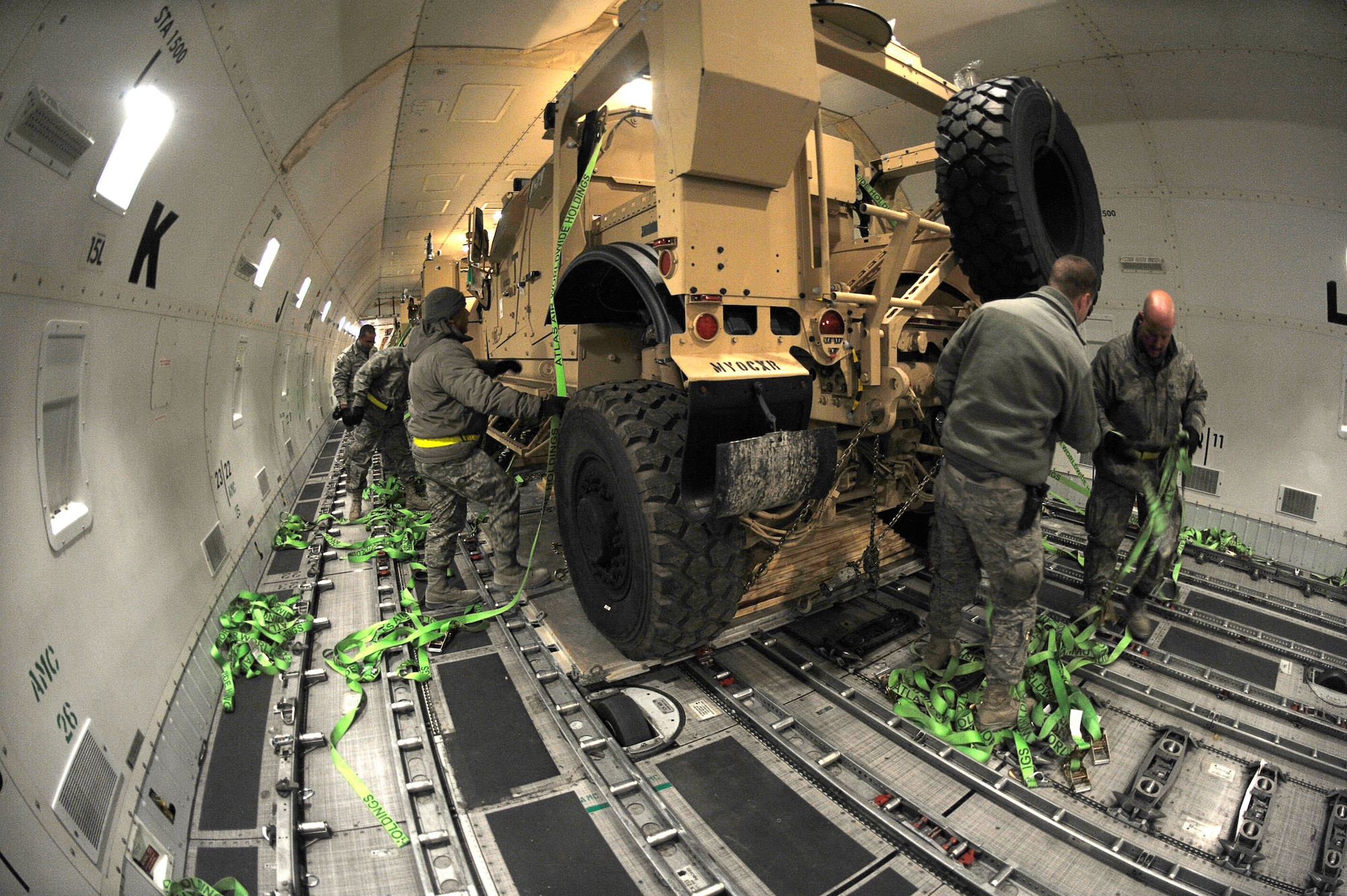 BAGRAM AIRFIELD, Afghanistan-- U.S. Air Force Airmen from the 455th Expeditionary Aerial Port Squadron, release the straps on a Mine Resistant Ambush Protected-All Terrain Vehicles (M-ATV) at Bagram Airfield Jan. 13, 2010.  The M-ATV is the latest combat vehicle used by U.S. combat forces. (U.S. Air Force photo by: Tech. Sgt. Jeromy K. Cross)
