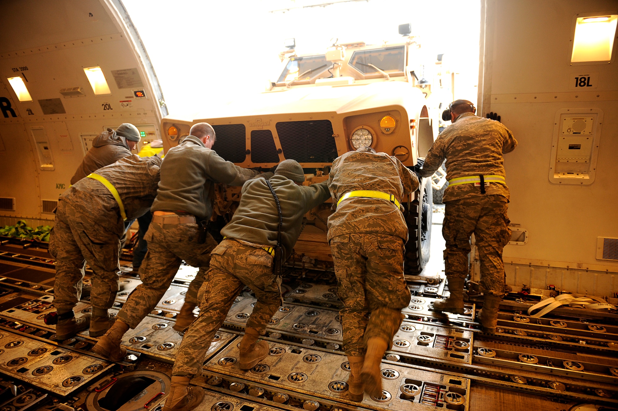 BAGRAM AIRFIELD, Afghanistan-- U.S. Air Force Airmen from the 455th Expeditionary Aerial Port Squadron, push a Mine Resistant Ambush Protected-All Terrain Vehicles (M-ATV) out of an aircraft at Bagram Airfield Jan. 13, 2010.  The M-ATV is the latest combat vehicle used by U.S. combat forces. (U.S. Air Force photo by: Tech. Sgt. Jeromy K. Cross)
