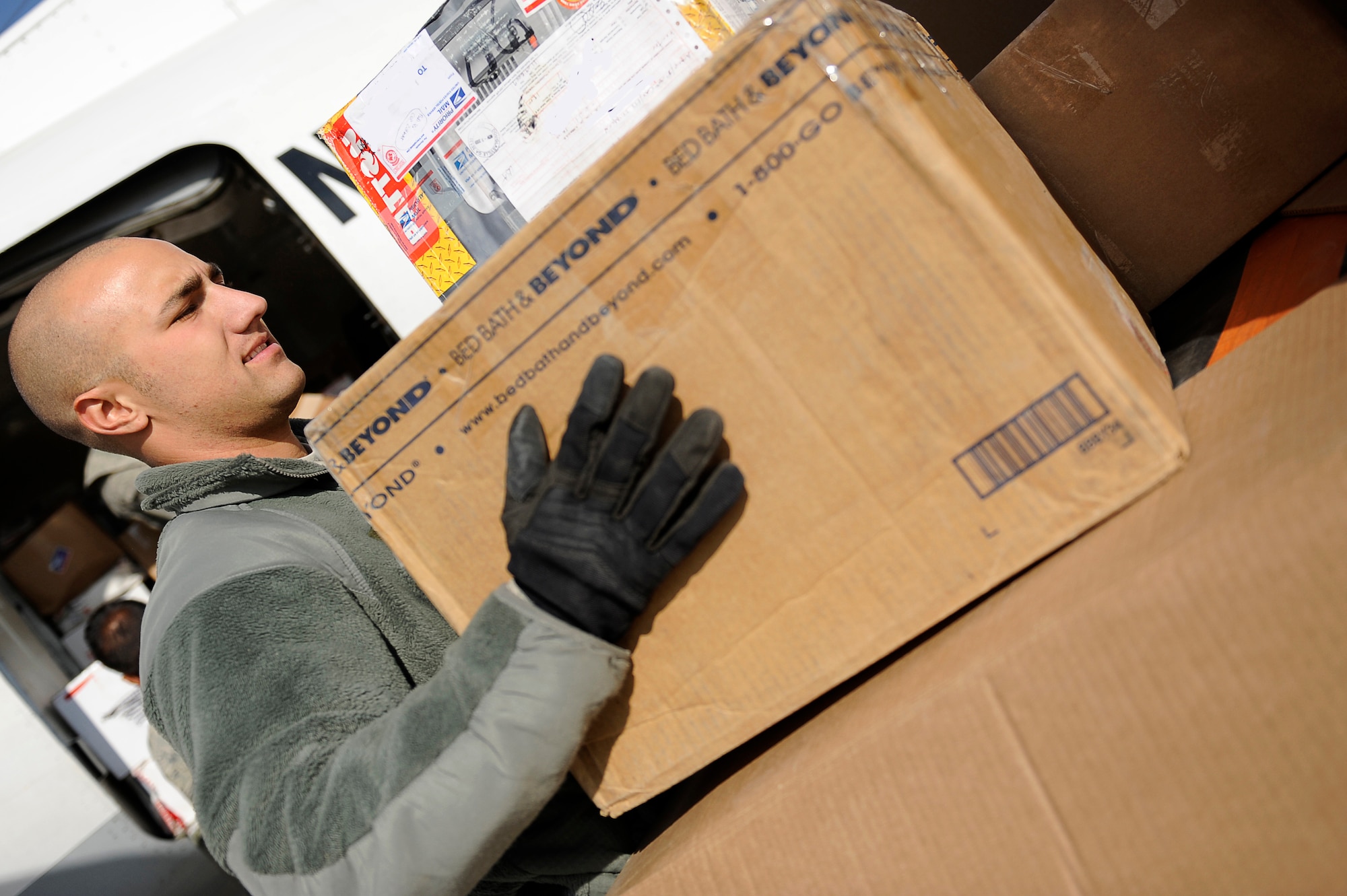 BAGRAM AIRFIELD, Afghanistan-- U.S. Air Force Senior Airman Joshua Shaffer, 455th Expeditionary Aerial Port Squadron, loads mail into an aircraft outbound to a nearby forward operating base at Bagram Airfield, Afghanistan, Jan.12, 2010.  Shaffer is a Reservist from Youngtown, Ohio. (U.S. Air Force photo by: Tech. Sgt. Jeromy K. Cross)
