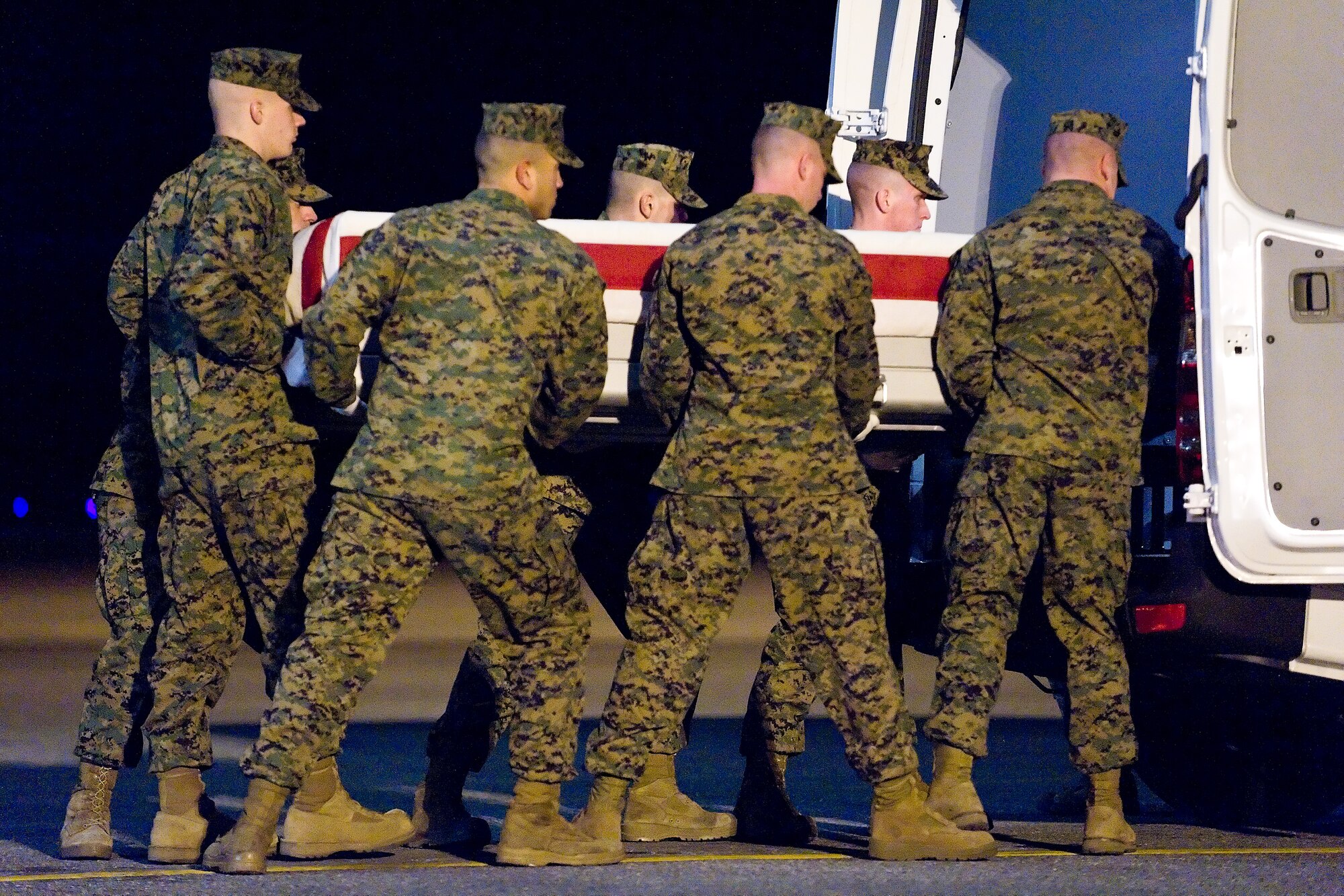 A U.S. Marine Corps team transfers the remains of Marine Corps Lance Cpl. Jacob A. Meinert, of Fort Atkinson, Wis., at Dover Air Force Base, Del., January 12. Lance Cpl. Meinert was assigned to 1st Battalion, 3rd Marine Regiment, 3rd Marine Division, III Marine Expeditionary Force, Kaneohe Bay, Hawaii. (U.S. Air Force photo/Roland Balik)