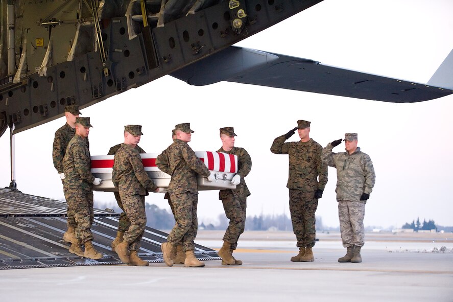 A U.S. Marine Corps team transfers the remains of Marine Corps Lance Cpl. Mark D. Juarez, of San Antonio, Texas, at Dover Air Force Base, Del., January 12. Lance Cpl. Juarez was assigned to 1st Battalion, 3rd Marine Regiment, 3rd Marine Division, III Marine Expeditionary Force, Kaneohe Bay, Hawaii. (U.S. Air Force photo/Roland Balik)