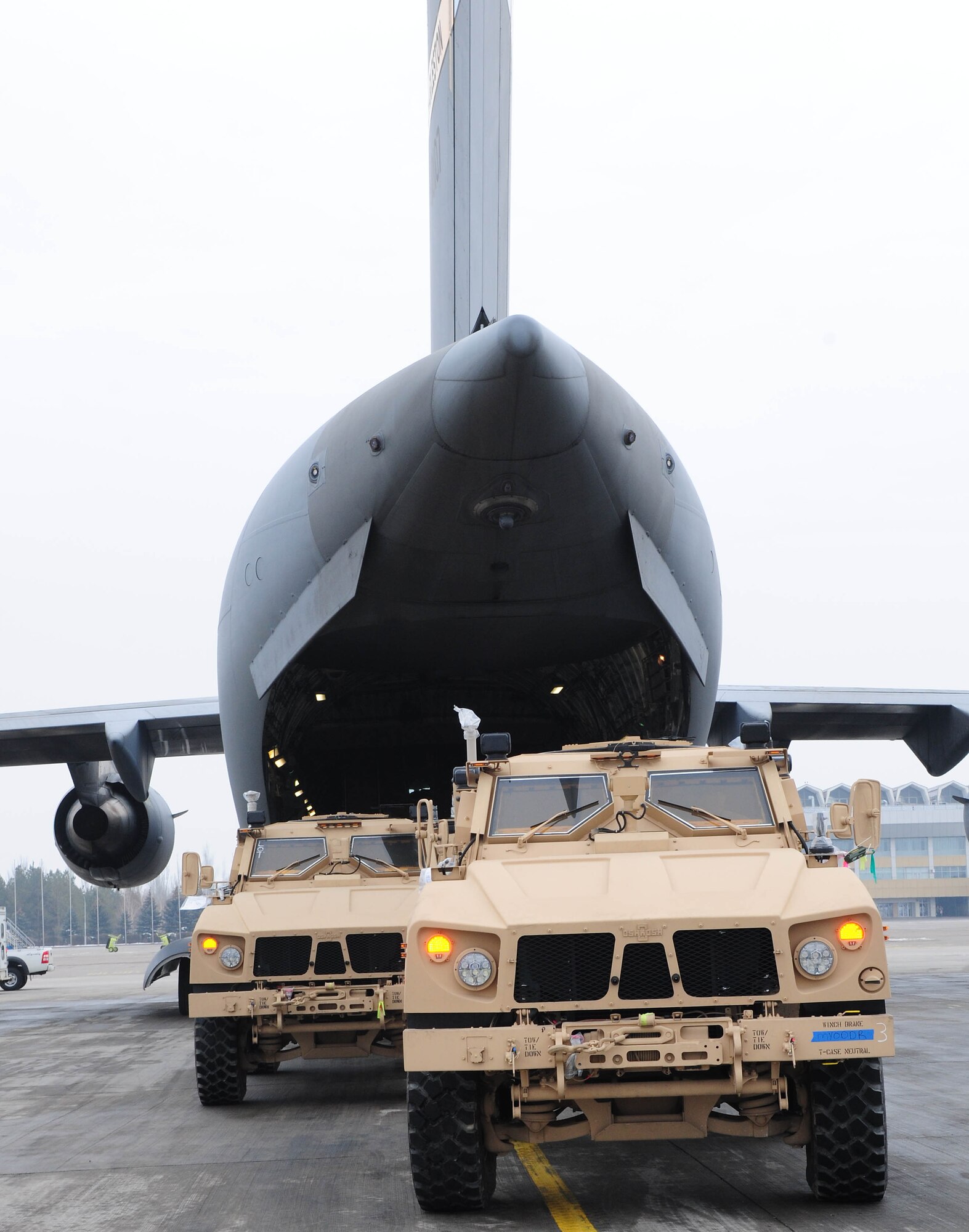 TRANSIT CENTER AT MANAS, Kyrgyzstan - Several MRAP-all terrain vehicles are loaded into a C-17 Globemaster III prior to shipment to Afghanistan. Several C-17s provide airlift for military servicemembers and cargo. (U.S. Air Force photo by Senior Airman Nichelle Anderson)