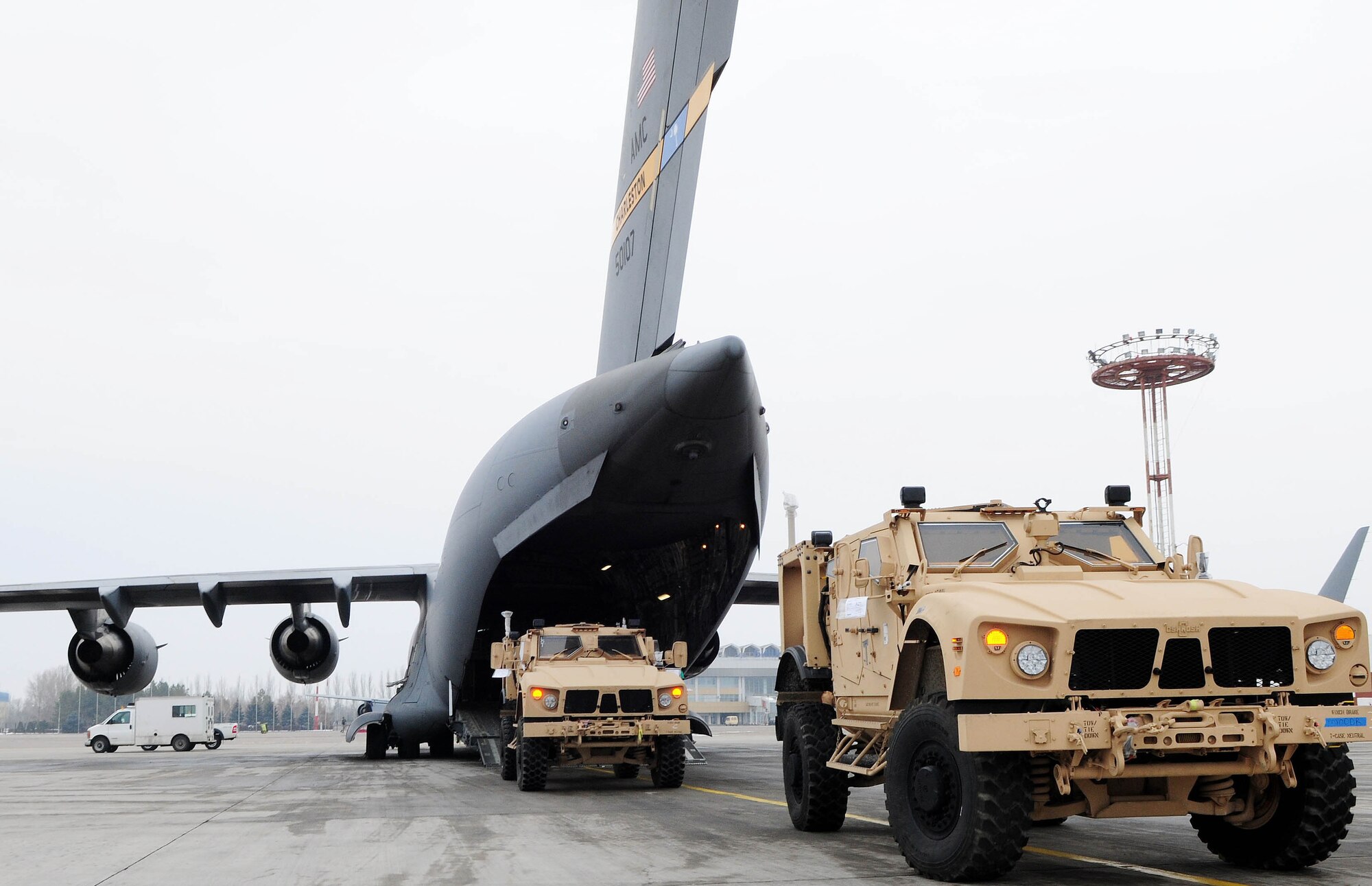 TRANSIT CENTER AT MANAS, Kyrgyzstan - Several MRAP-all terrain vehicles are loaded into a C-17 Globemaster III prior to shipment to Afghanistan. Several C-17s provide airlift for military servicemembers and cargo. (U.S. Air Force photo by Senior Airman Nichelle Anderson)