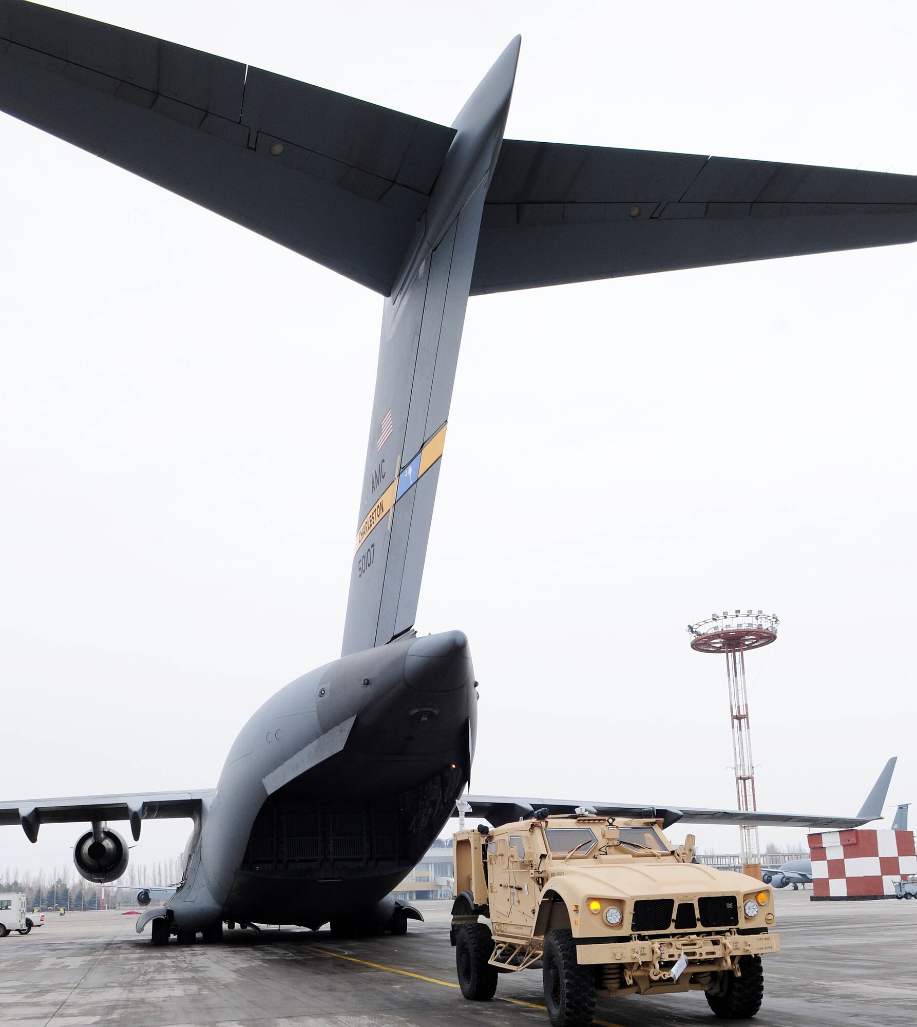 TRANSIT CENTER AT MANAS, Kyrgyzstan - An MRAP-all terrain vehicle is in position to be loaded into a C-17 Globemaster III prior to shipment to Afghanistan. The new M-ATVs are better equipped to withstand current combat conditions. Several C-17s provide airlift for military servicemembers and cargo. (U.S. Air Force photo by Senior Airman Nichelle Anderson)
