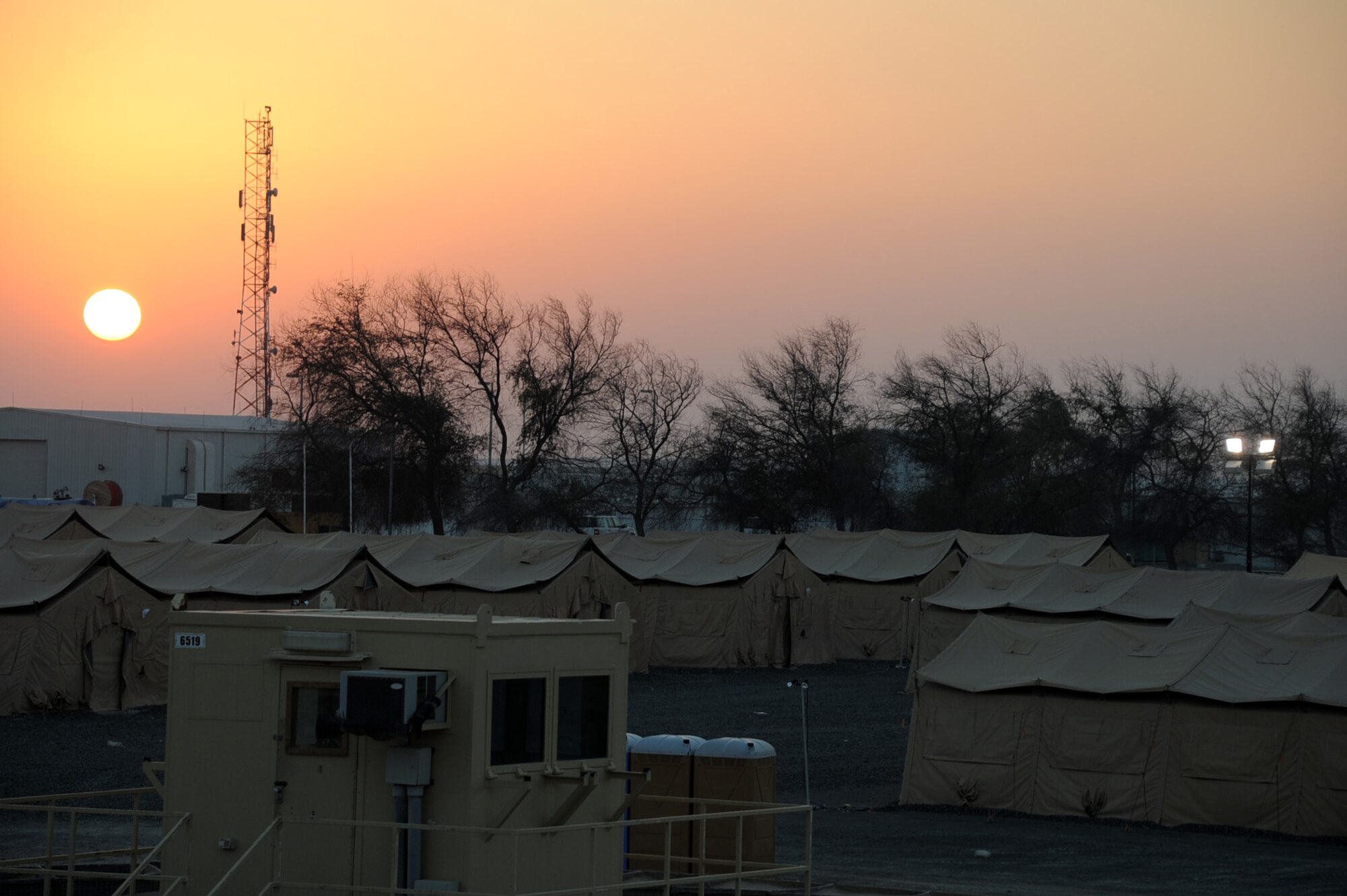 The sun sets over the camp for the 380th Air Expeditionary Wing at a non-disclosed base in Southwest Asia.  The 380th Air Expeditionary Wing supports Operations Iraqi Freedom and Enduring Freedom and the Combined Joint Task Force-Horn of Africa.  (U.S. Air Force Photo/Tech. Sgt. Scott T. Sturkol/Released)