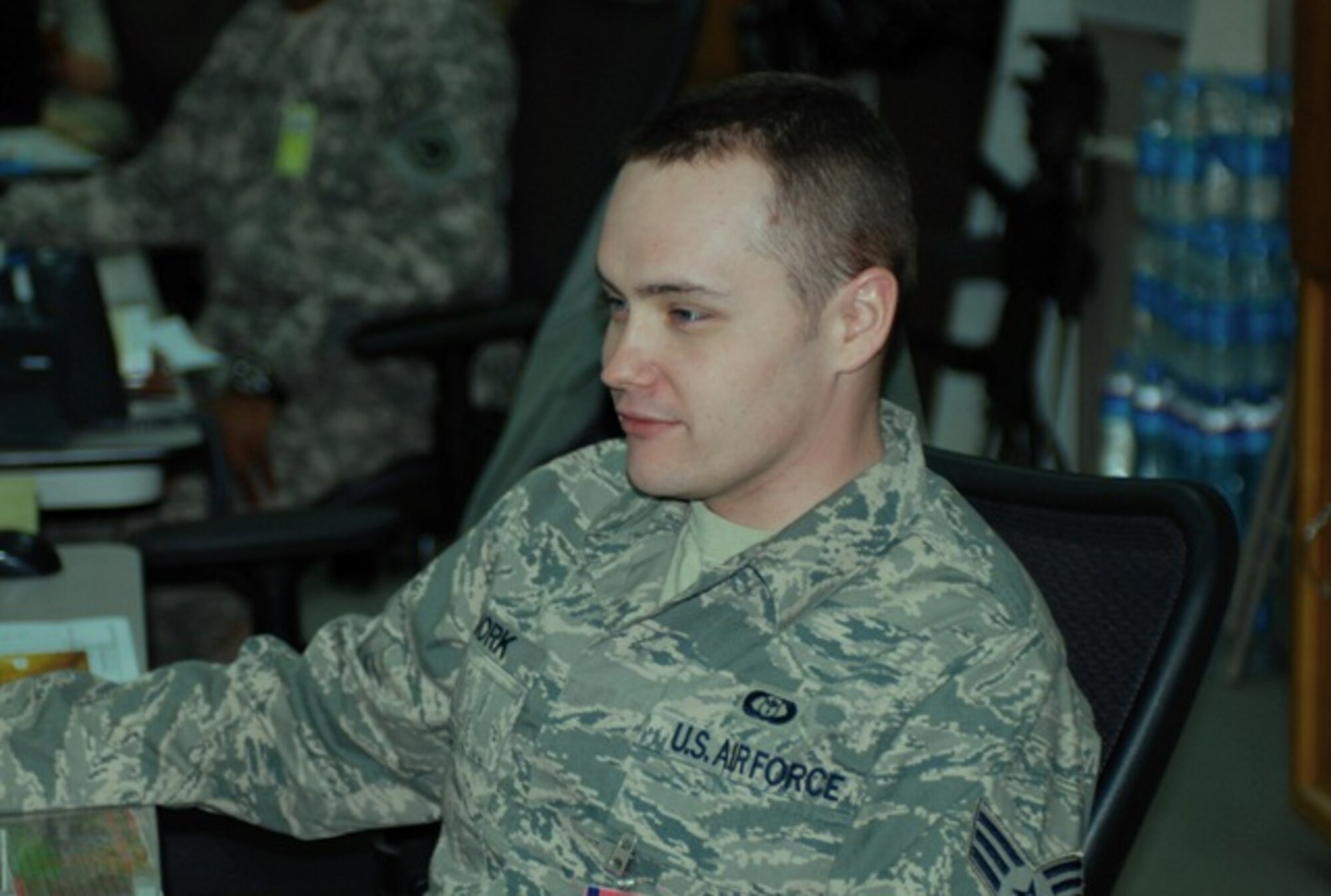 BAGRAM AIRFIELD, Afghanistan - U.S. Air Force Senior Airmen Jarod Bjork, from Orlando, Fla., mans his battle-station at the Combined Joint Task Force-82’s joint operations command center, Jan10. Bjork uses advanced equipment to monitor the weather and give recommendations that are used by the war-fighters on the ground to plan and execute missions. (U.S. Army photo by Spc. B. Todd Willis, Combined Joint Task Force-82 Public Affairs)